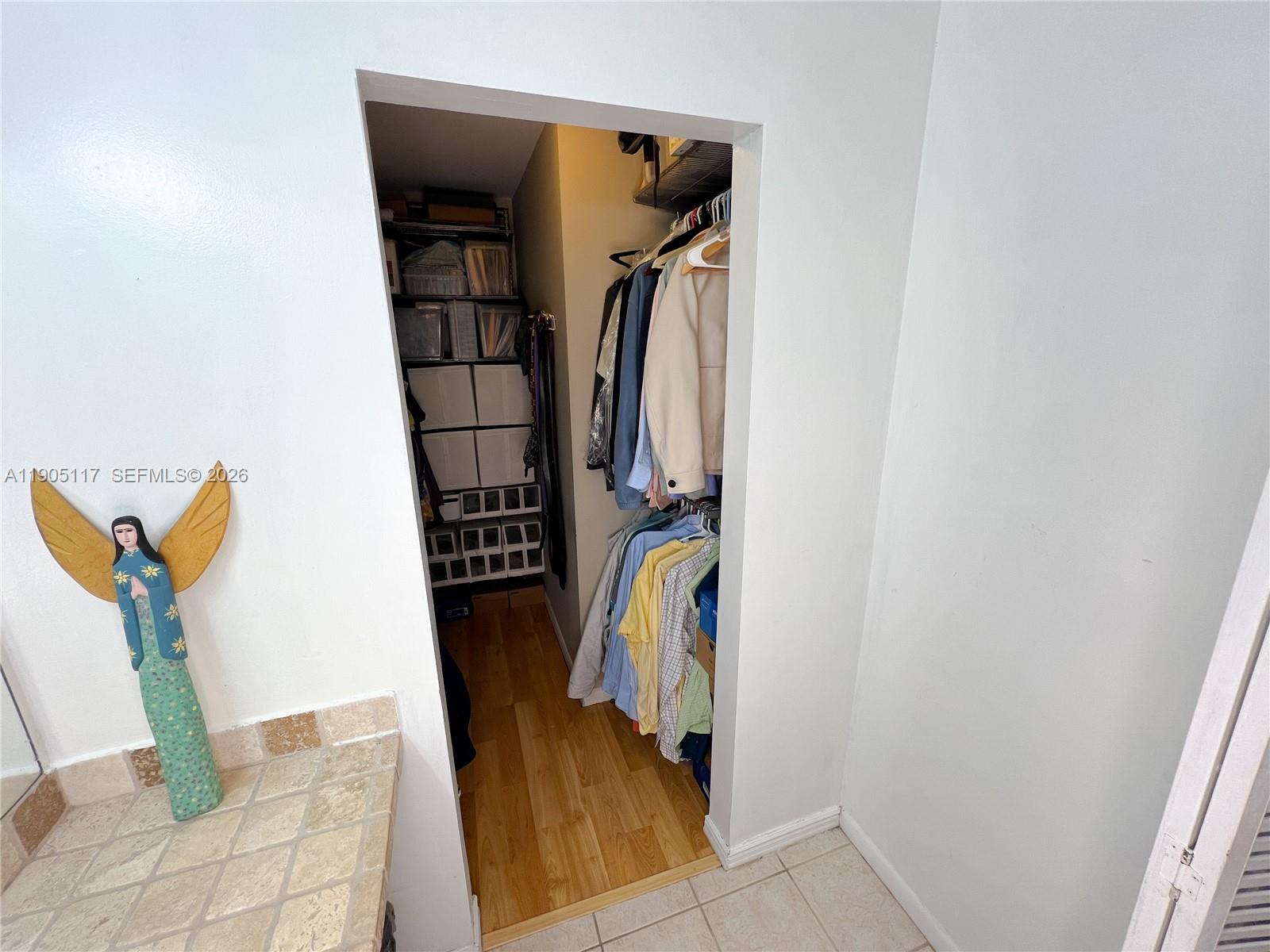4555 Southwest 68th Ct Circle, Unit 111 Miami, FL 33155 - Photo 24 of 33 a view of walk in closet with clothes and shoes