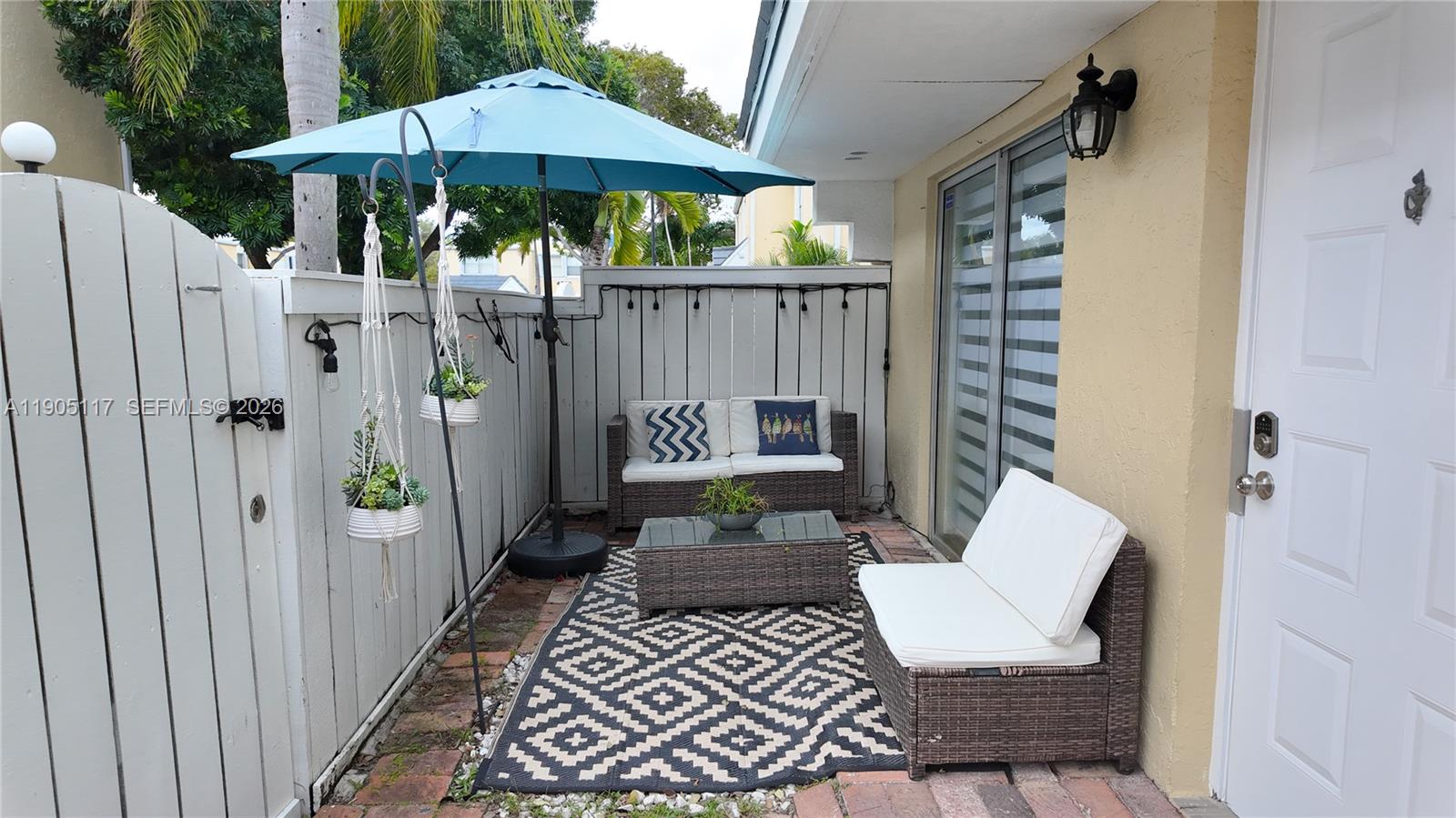 4555 Southwest 68th Ct Circle, Unit 111 Miami, FL 33155 - Photo 29 of 33 a view of a patio with furniture and umbrella