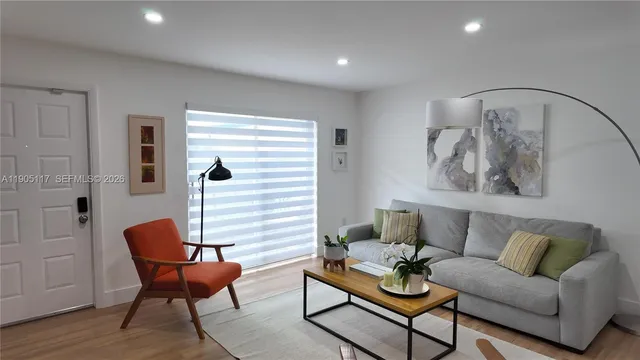 a living room with furniture and wooden floor