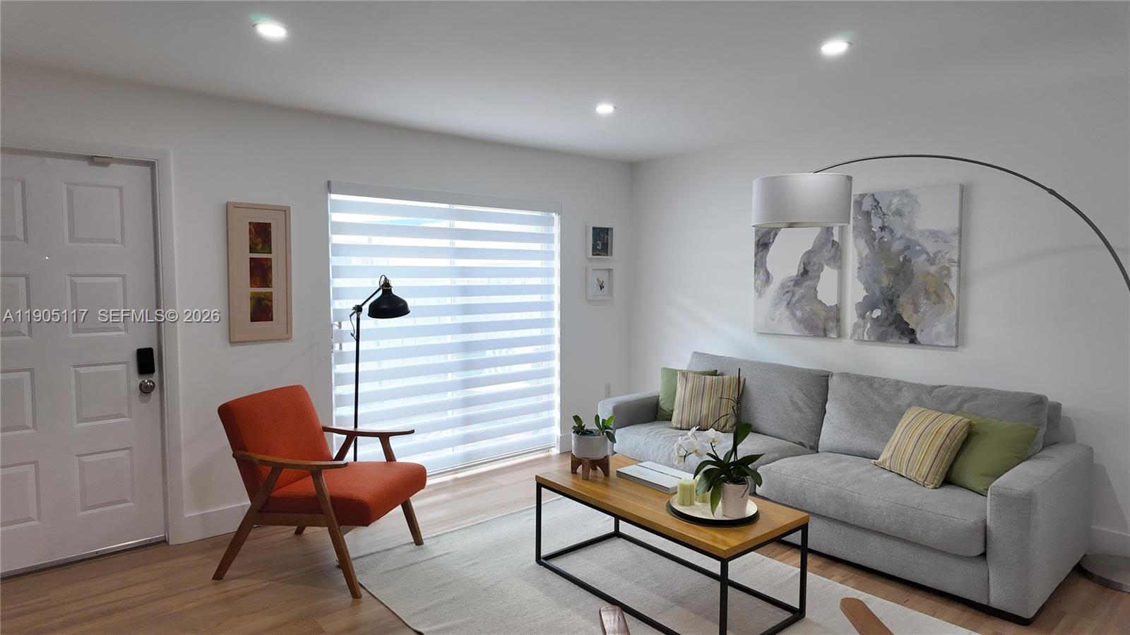 4555 Southwest 68th Ct Circle, Unit 111 Miami, FL 33155 - Photo 3 of 33 a living room with furniture and wooden floor