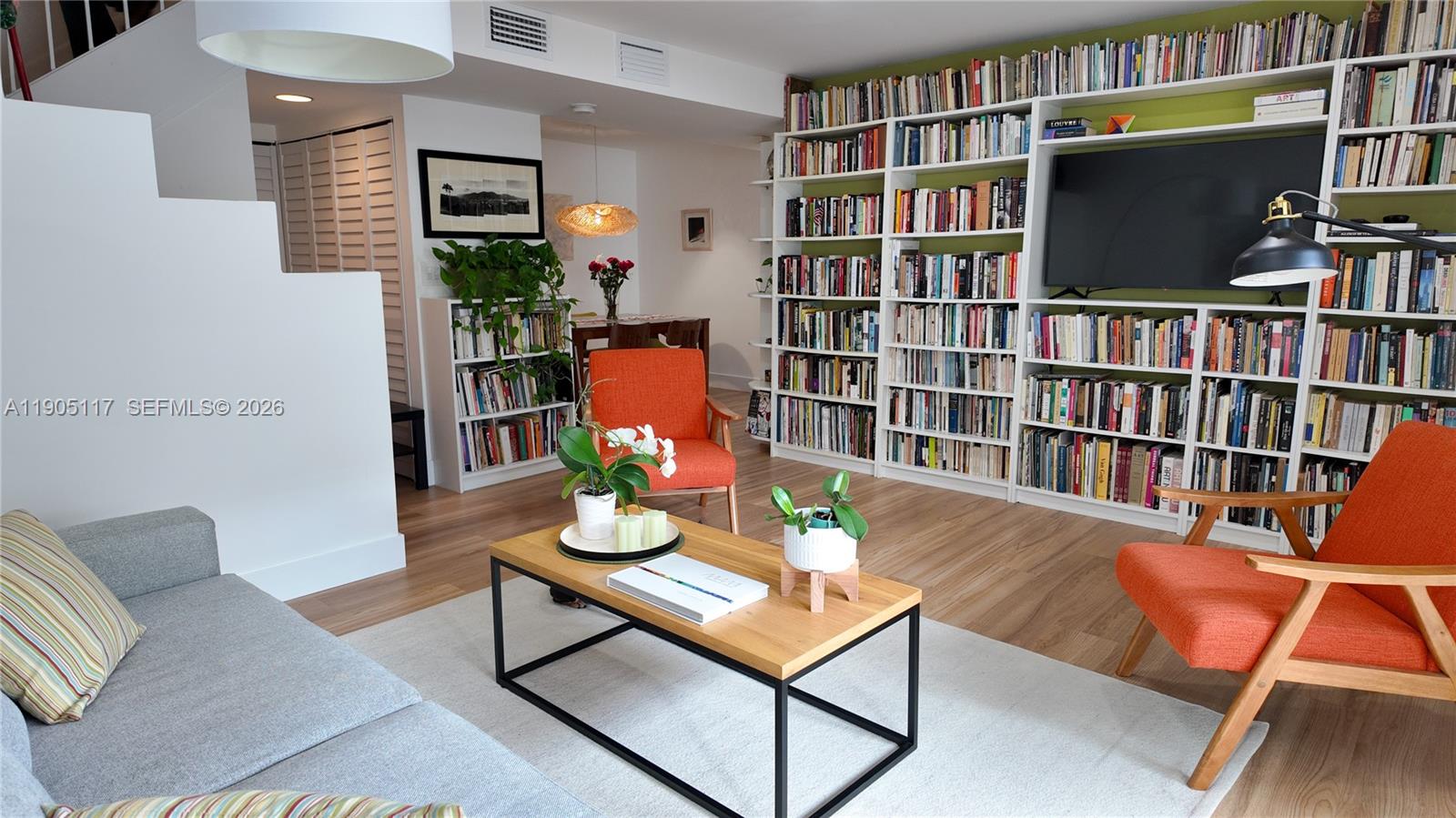 4555 Southwest 68th Ct Circle, Unit 111 Miami, FL 33155 - Photo 7 of 33 a living room with a book shelf and a book shelf