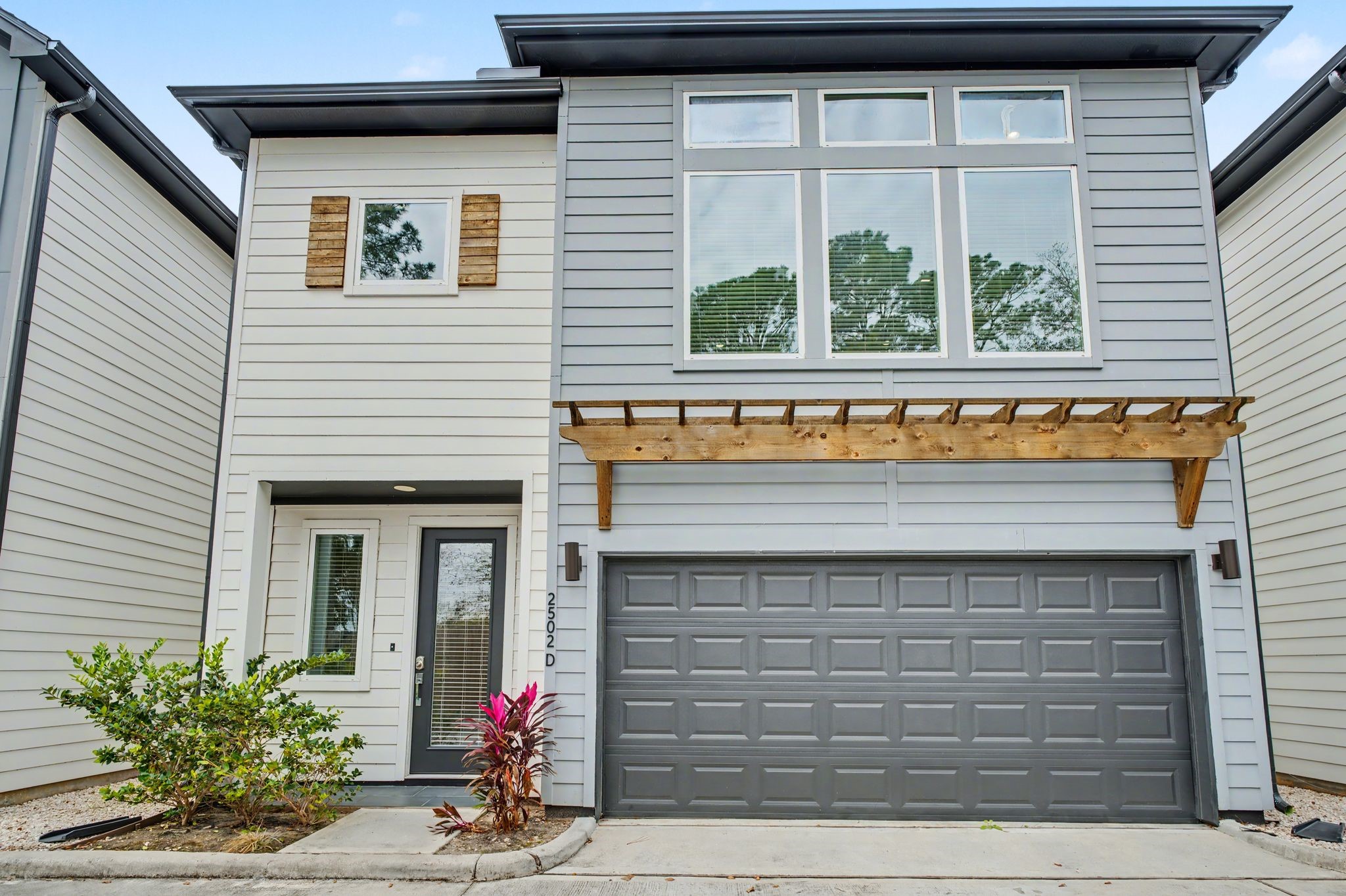 2502 West Tidwell Road, Unit D Houston, TX 77091 - Photo 1 of 24 a view of front door of house with potted plants