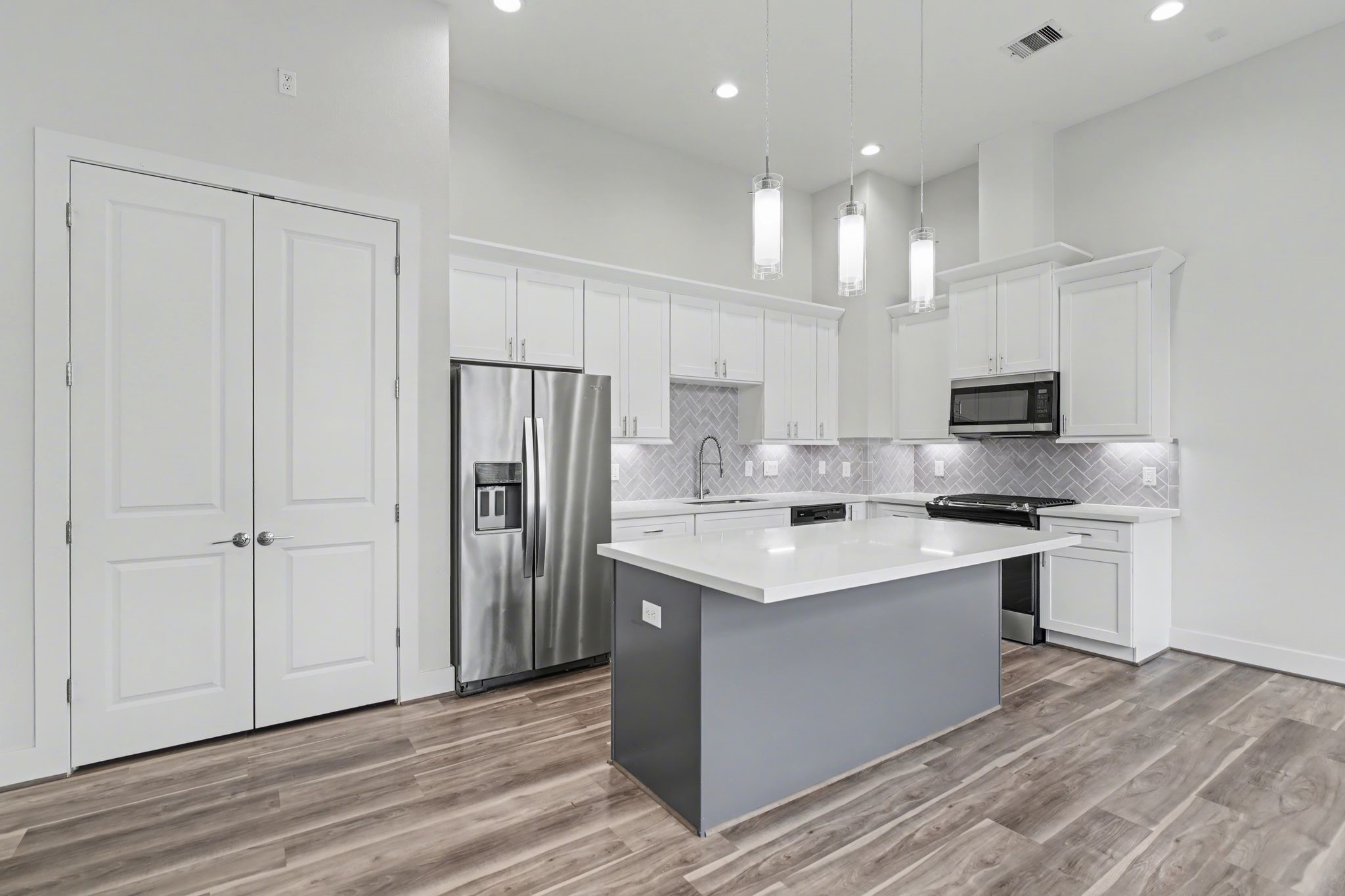 2502 West Tidwell Road, Unit D Houston, TX 77091 - Photo 12 of 24 a kitchen with kitchen island a sink stainless steel appliances and cabinets
