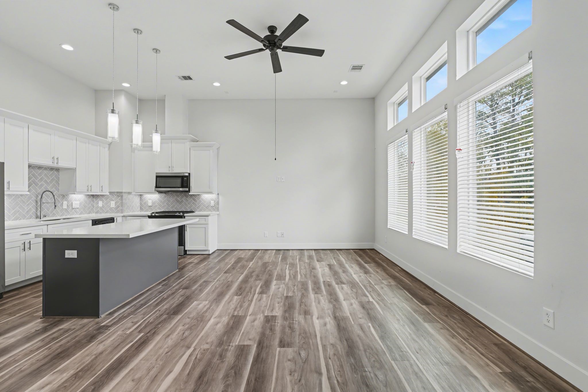 2502 West Tidwell Road, Unit D Houston, TX 77091 - Photo 15 of 24 a large kitchen with kitchen island a sink dishwasher a stove and a refrigerator