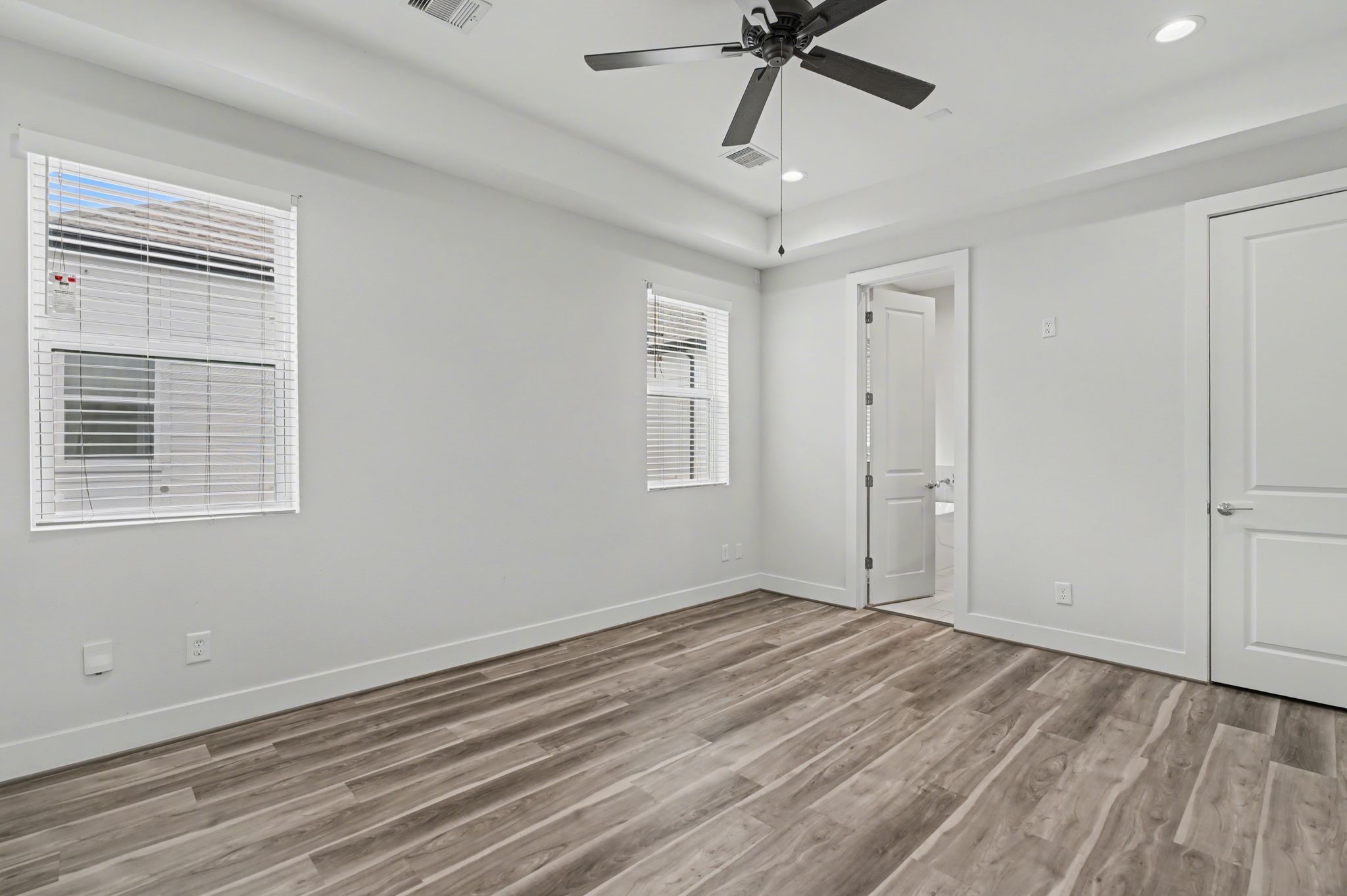 2502 West Tidwell Road, Unit D Houston, TX 77091 - Photo 16 of 24 a view of empty room with wooden floor and fan