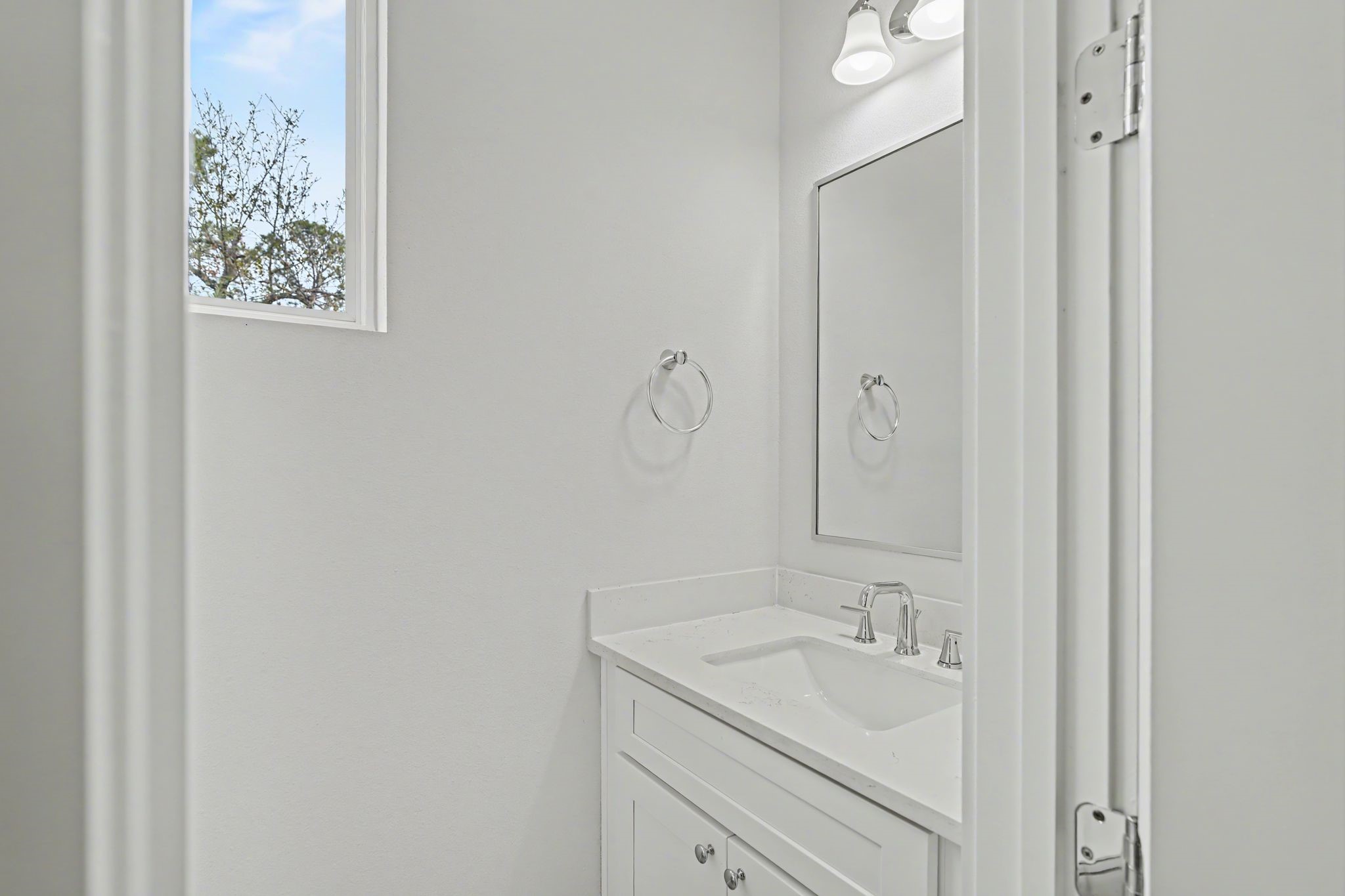 2502 West Tidwell Road, Unit D Houston, TX 77091 - Photo 22 of 24 a bathroom with a sink and a mirror