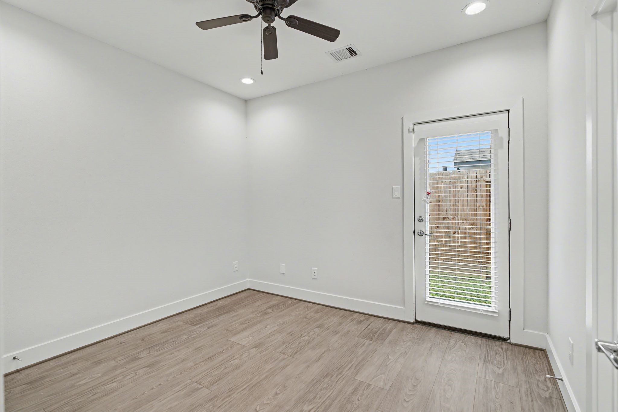 2502 West Tidwell Road, Unit D Houston, TX 77091 - Photo 7 of 24 wooden floor in an empty room with a window