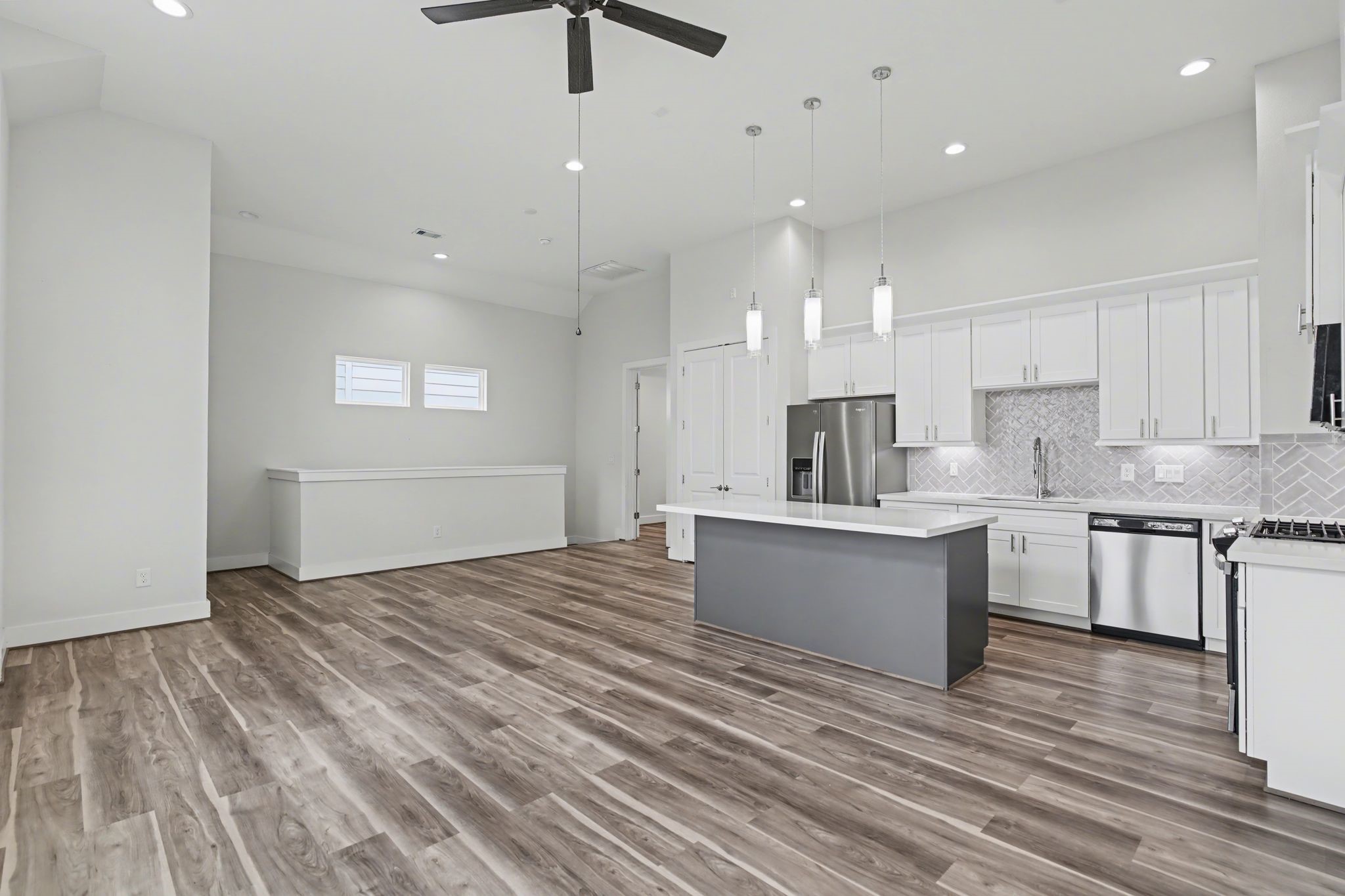 2502 West Tidwell Road, Unit D Houston, TX 77091 - Photo 10 of 24 a large kitchen with kitchen island a sink stainless steel appliances and cabinets
