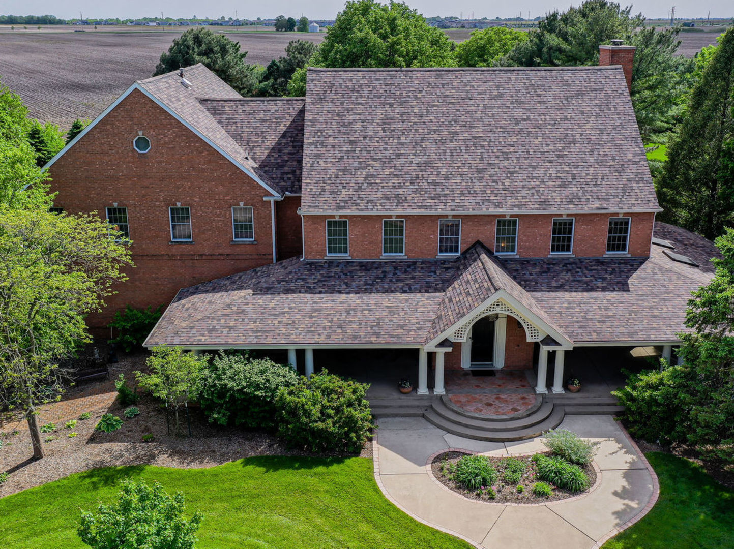 an aerial view of a house with garden space and patio
