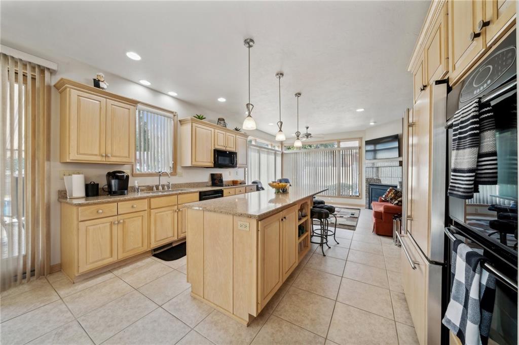 339 Kathy Drive Belle Vernon, PA 15012 - Photo 12 of 48 a kitchen with stainless steel appliances kitchen island granite countertop a stove and a sink