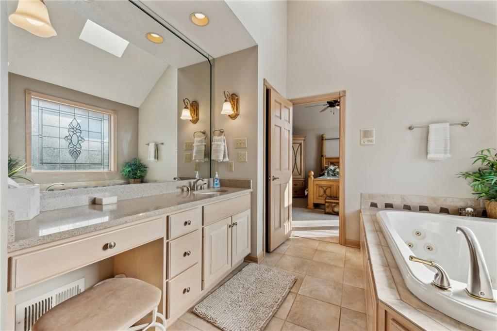 339 Kathy Drive Belle Vernon, PA 15012 - Photo 24 of 48 a spacious en suite bathroom with a granite countertop tub and a double vanity sink mirror