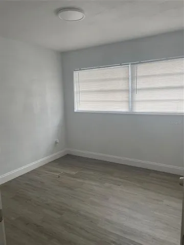a view of a small space with wooden floor and windows