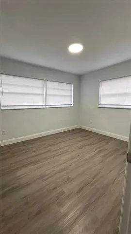 a view of wooden floor and cabinet in a room