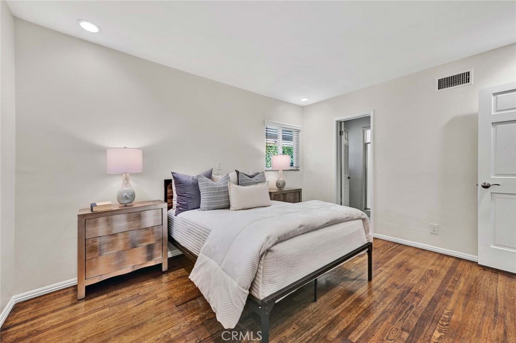 5411 Cadbury Road Whittier, CA 90601 - Photo 16 of 50 Primary bedroom with access to bathroom, wood flooring, and recessed lighting