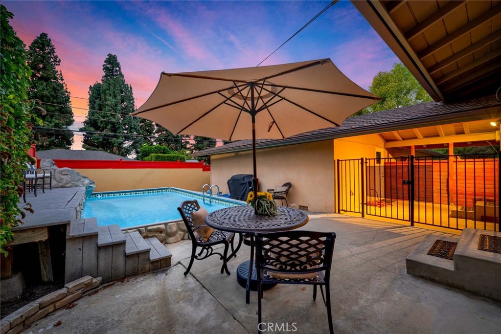 5411 Cadbury Road Whittier, CA 90601 - Photo 28 of 50 Backyard retreat featuring a pool, patio dining, and a beautiful evening ambiance.