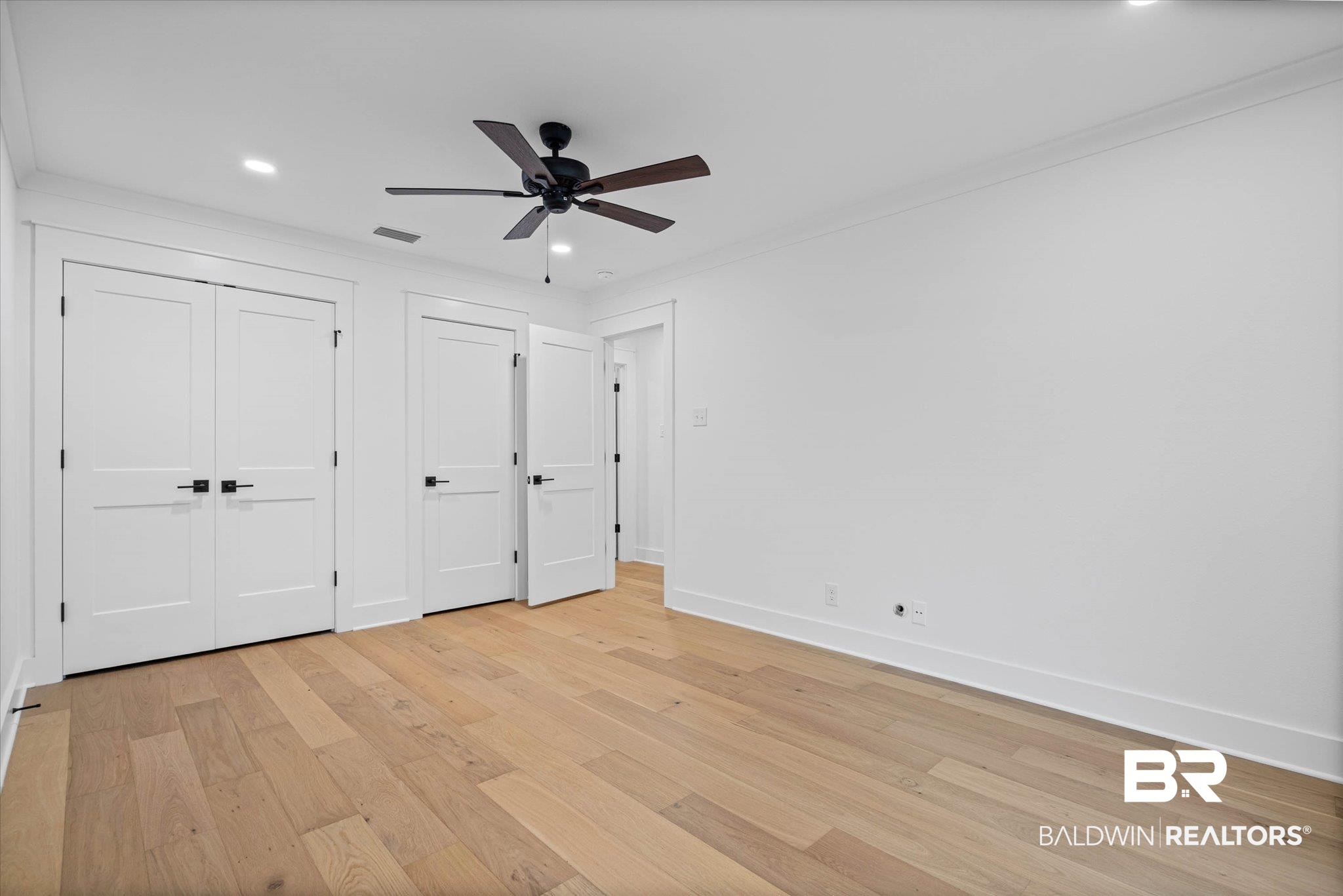 11 Schwaemmle Drive Mobile, AL 36608 - Photo 25 of 32 Unfurnished bedroom featuring crown molding, multiple closets, light wood-style floors, ceiling fan, and recessed lighting