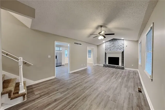 wooden floor in an empty room with a fireplace