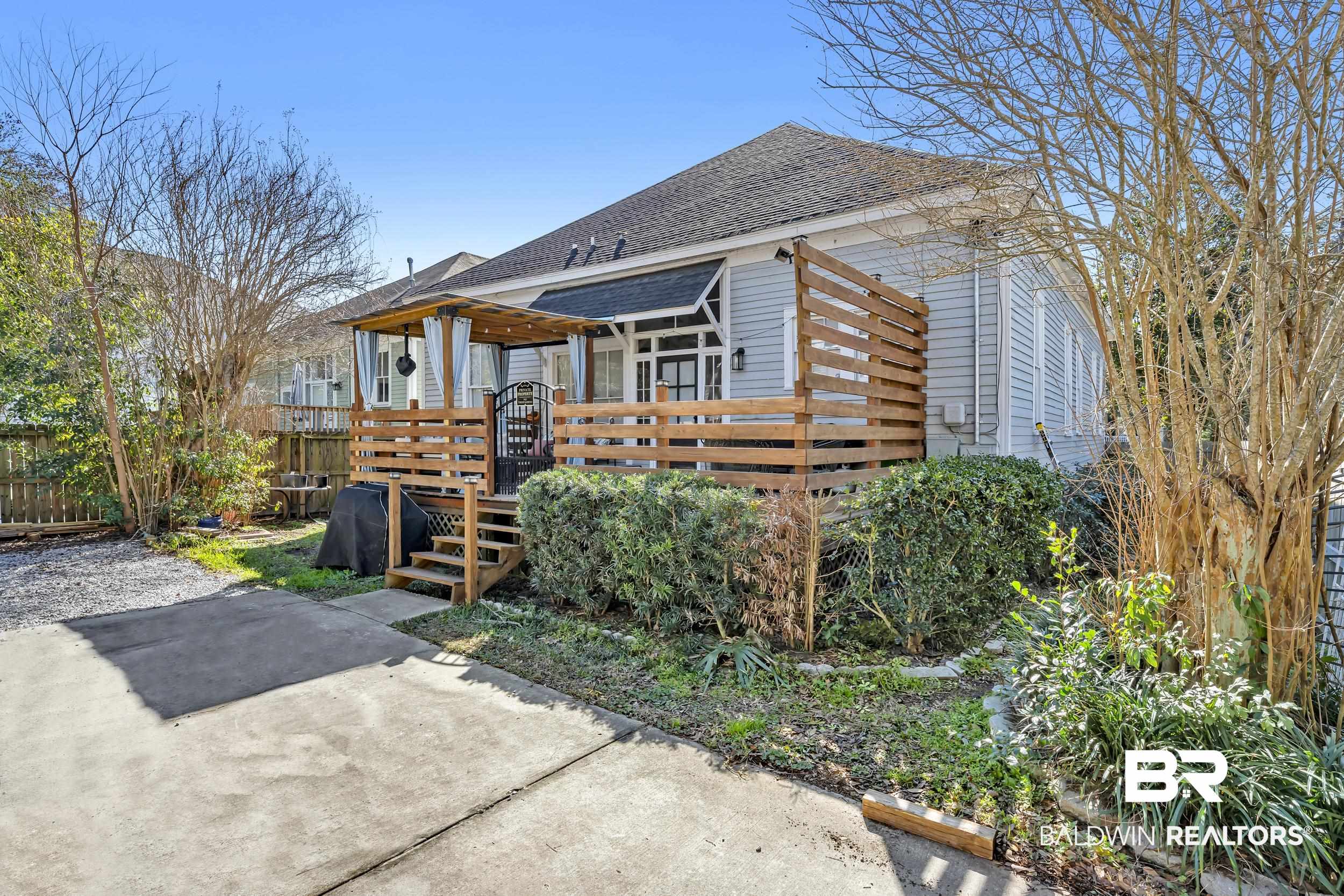 1322 Dauphin Street Mobile, AL 36604 - Photo 20 of 21 View of front of house featuring a shingled roof and a deck