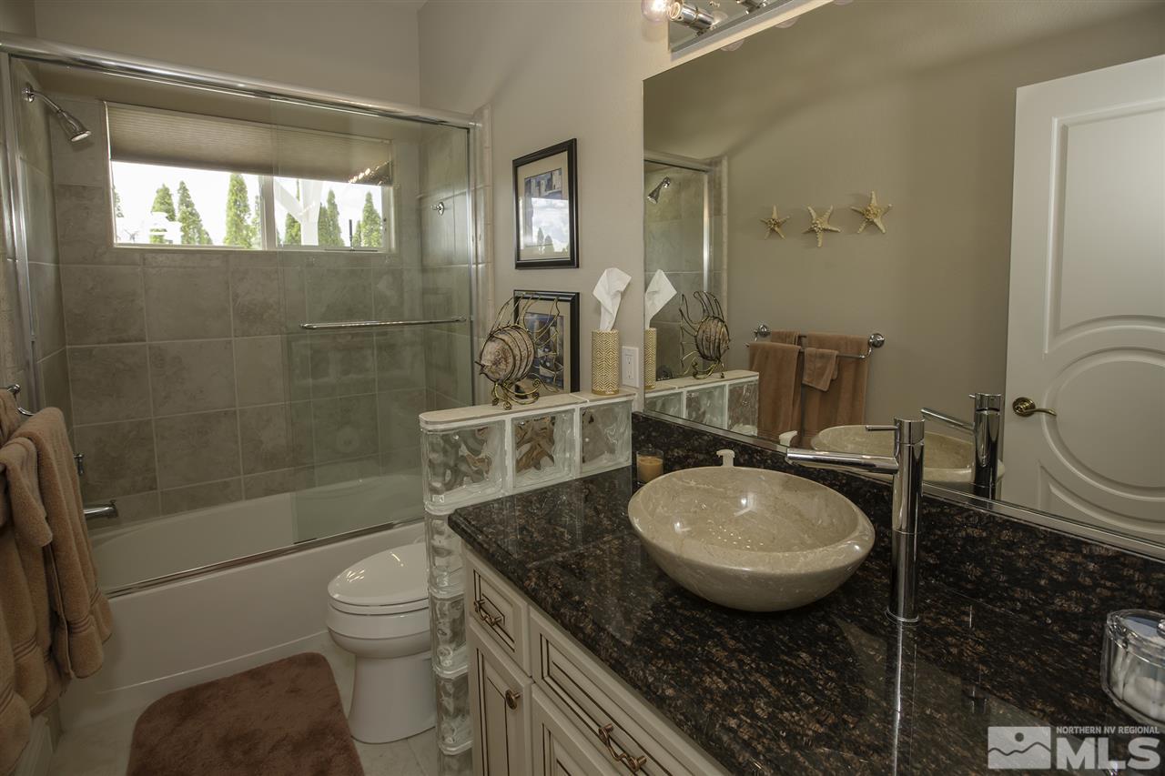 950 Stadium View Court Reno, NV 89512 - Photo 15 of 25 a bathroom with a granite countertop toilet sink shower and mirror