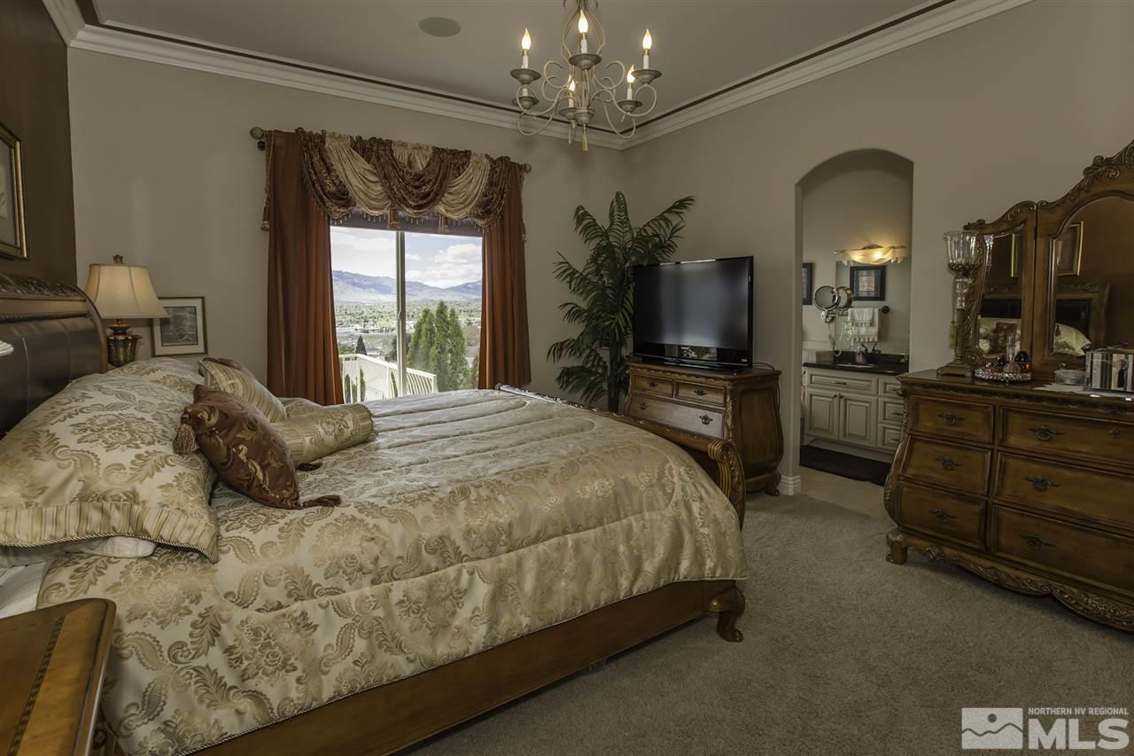 950 Stadium View Court Reno, NV 89512 - Photo 19 of 25 a bedroom with a bed and a flat tv screen on dresser
