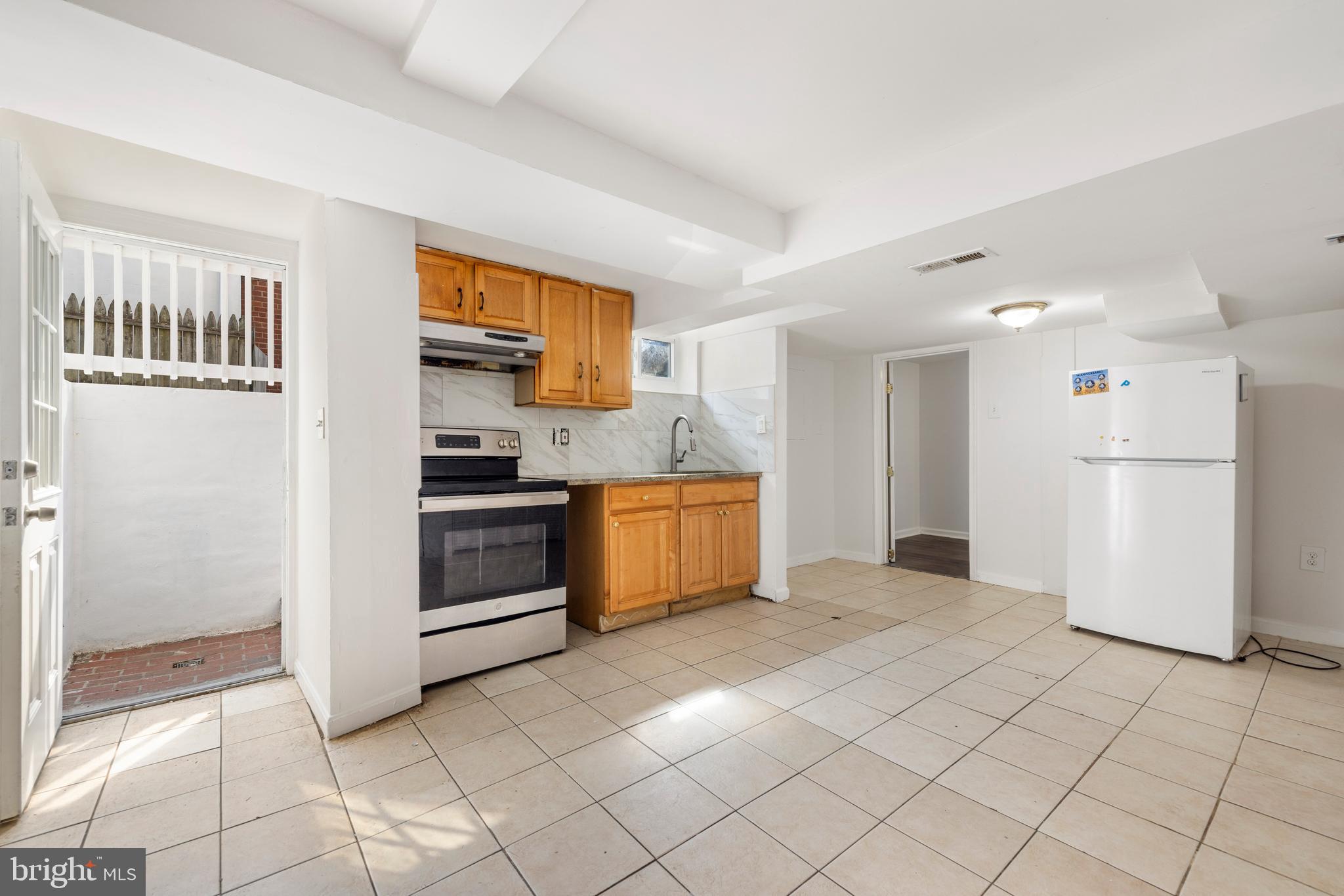12025 Claridge Road Silver Spring, MD 20902 - Photo 24 of 25 a kitchen with a cabinets and a stove top oven