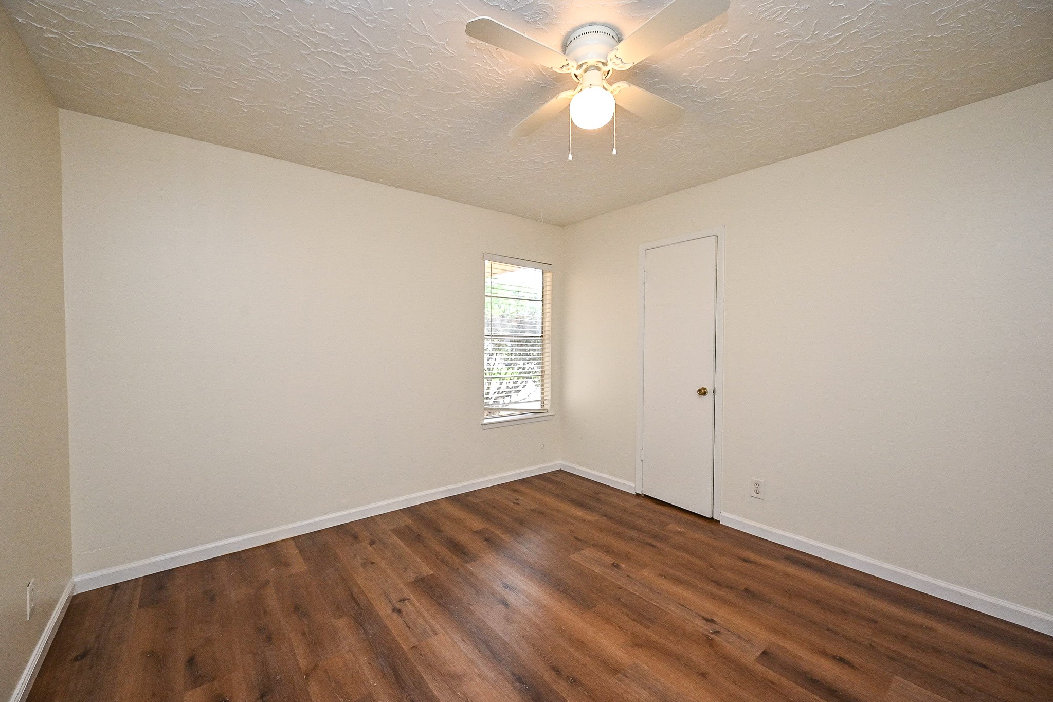 23814 Spring Gum Drive Spring, TX 77373 - Photo 6 of 21 an empty room with wooden floor fan and windows