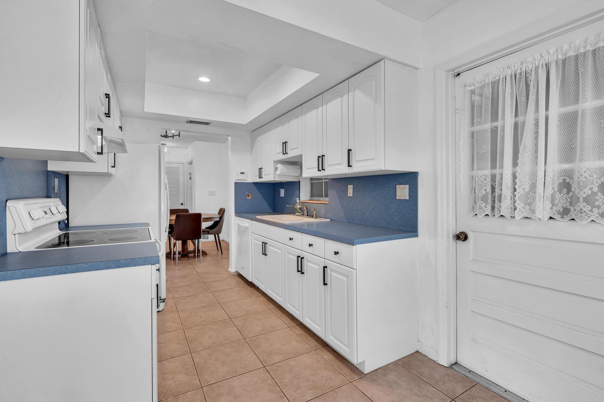 313 Northwest 42nd Street Boca Raton, FL 33431 - Photo 14 of 42 a kitchen with stainless steel appliances granite countertop a stove a sink and a refrigerator