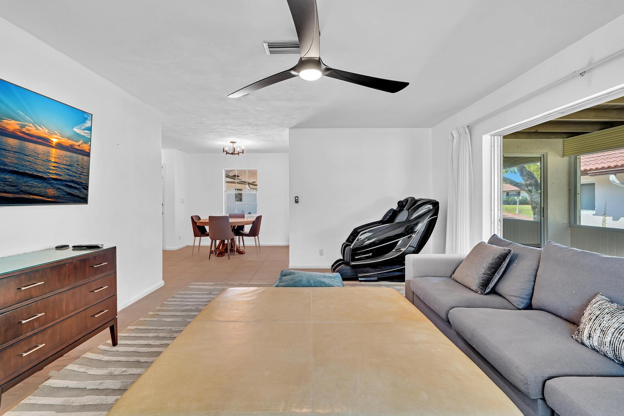 313 Northwest 42nd Street Boca Raton, FL 33431 - Photo 16 of 42 a living room with furniture and a flat screen tv