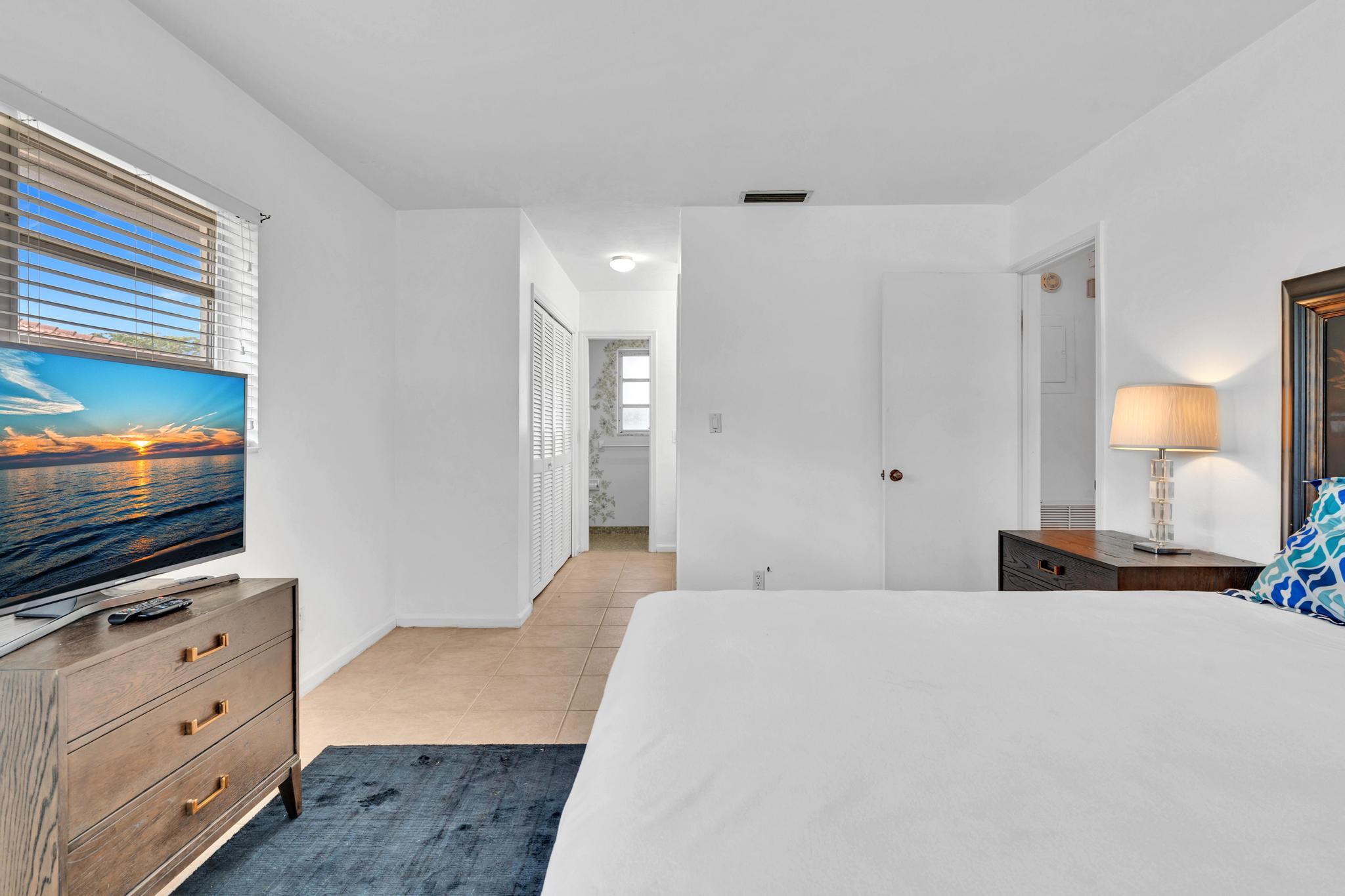 313 Northwest 42nd Street Boca Raton, FL 33431 - Photo 22 of 42 a bedroom with a bed and a flat screen tv