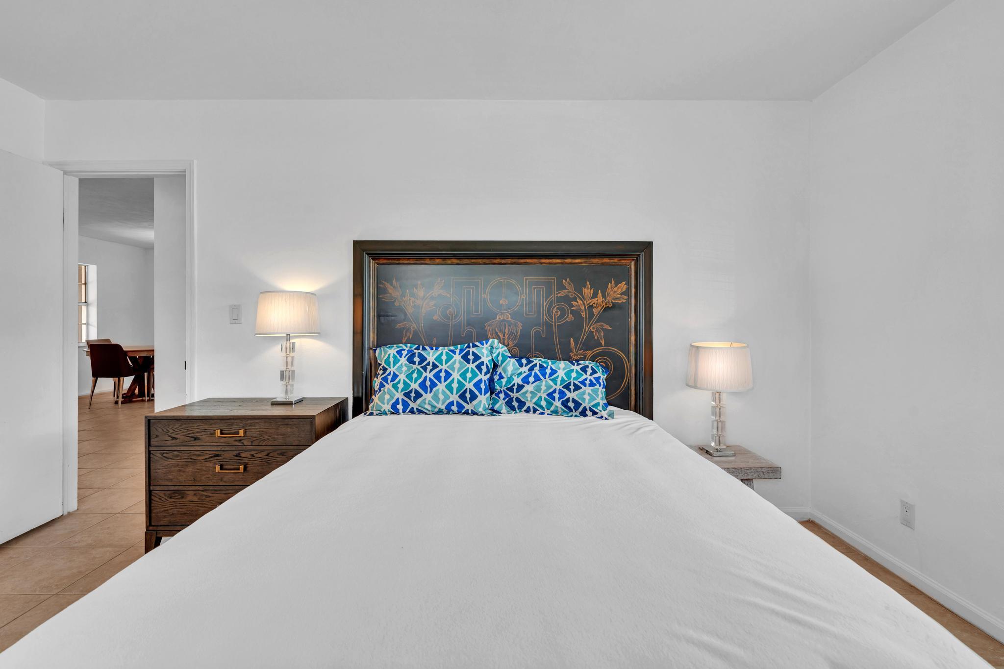 313 Northwest 42nd Street Boca Raton, FL 33431 - Photo 23 of 42 a bedroom with a bed and a lamp