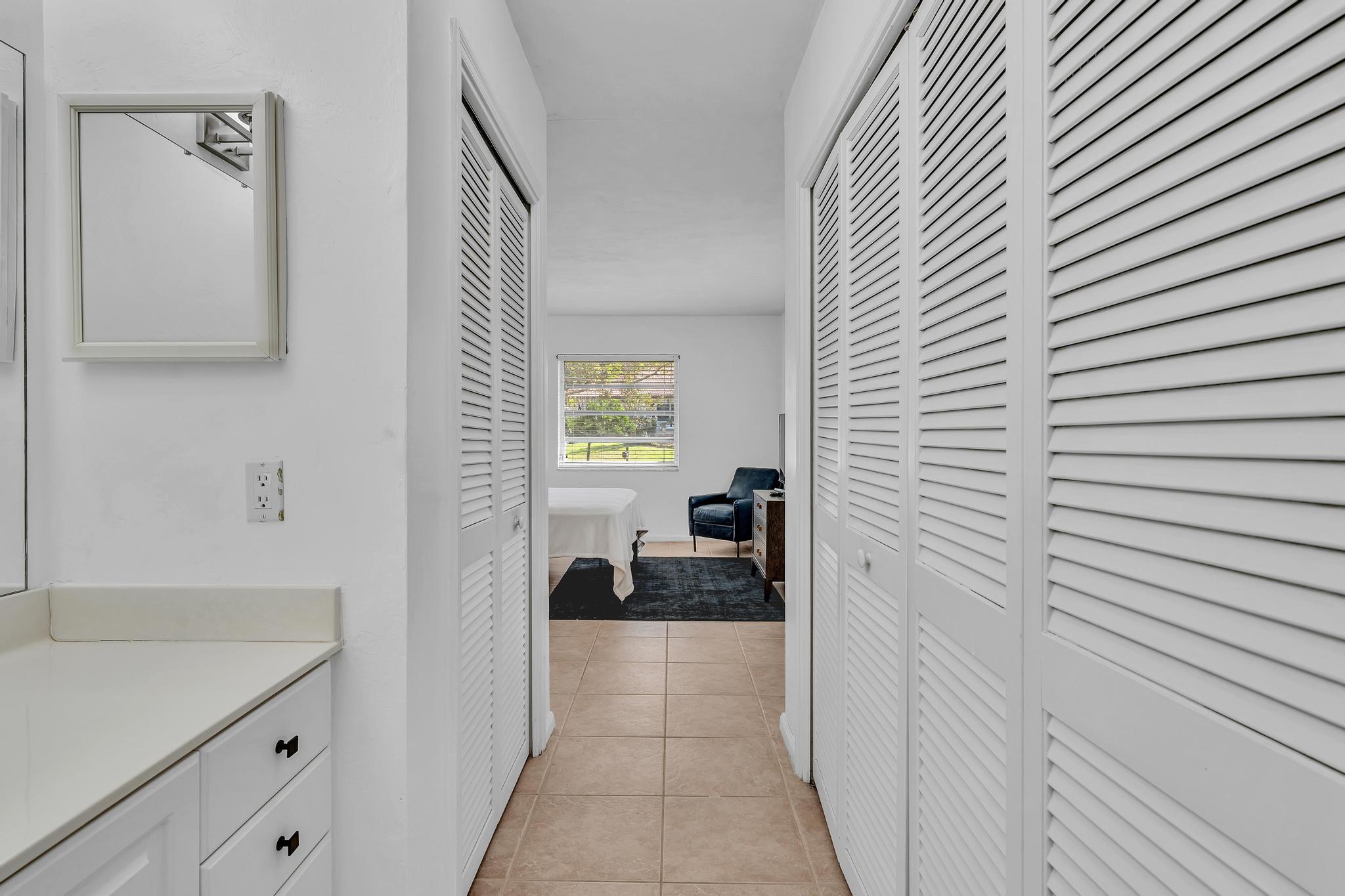 313 Northwest 42nd Street Boca Raton, FL 33431 - Photo 27 of 42 a bedroom with a bed and a window