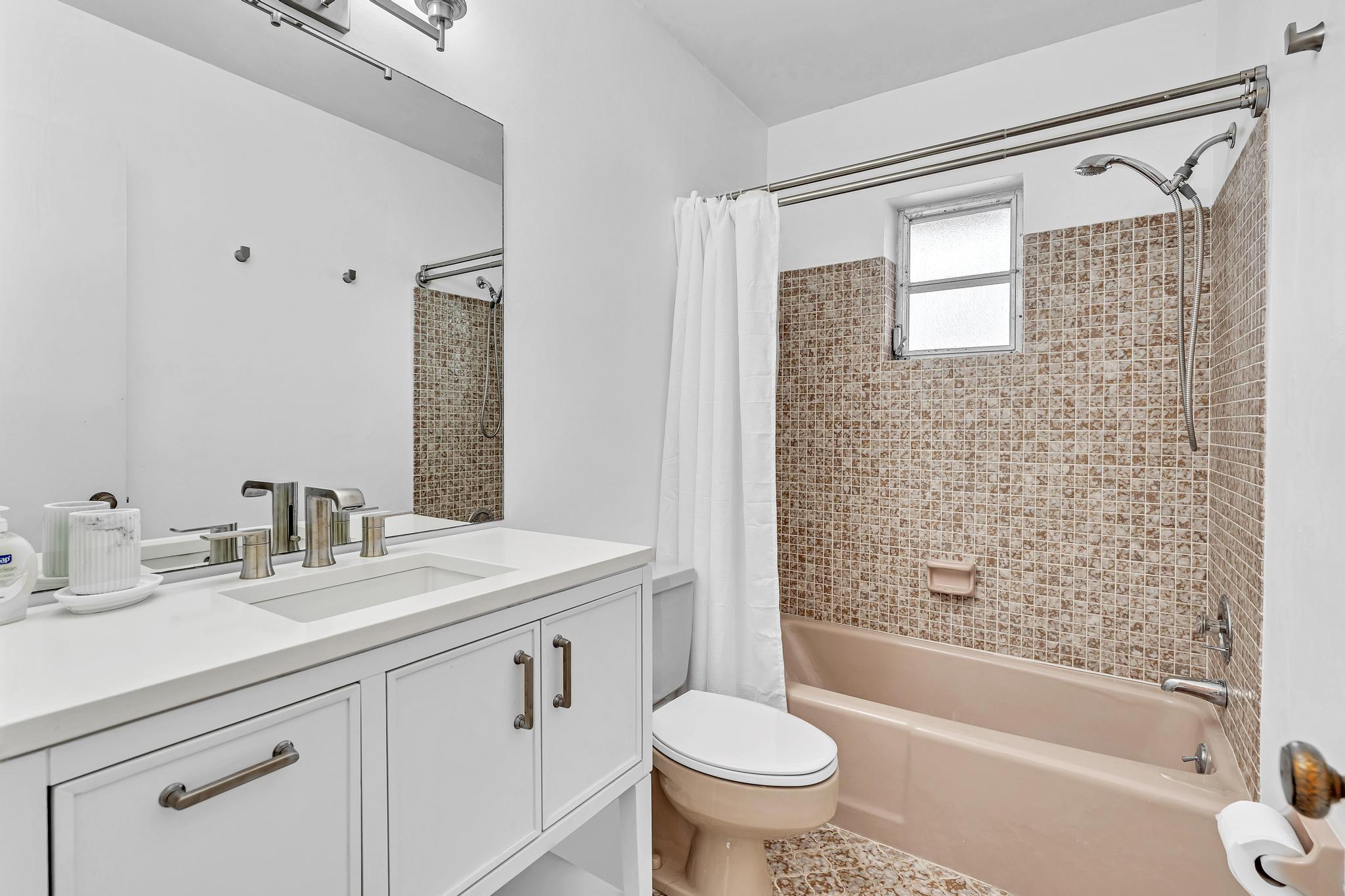 313 Northwest 42nd Street Boca Raton, FL 33431 - Photo 29 of 42 a bathroom with a sink toilet and shower