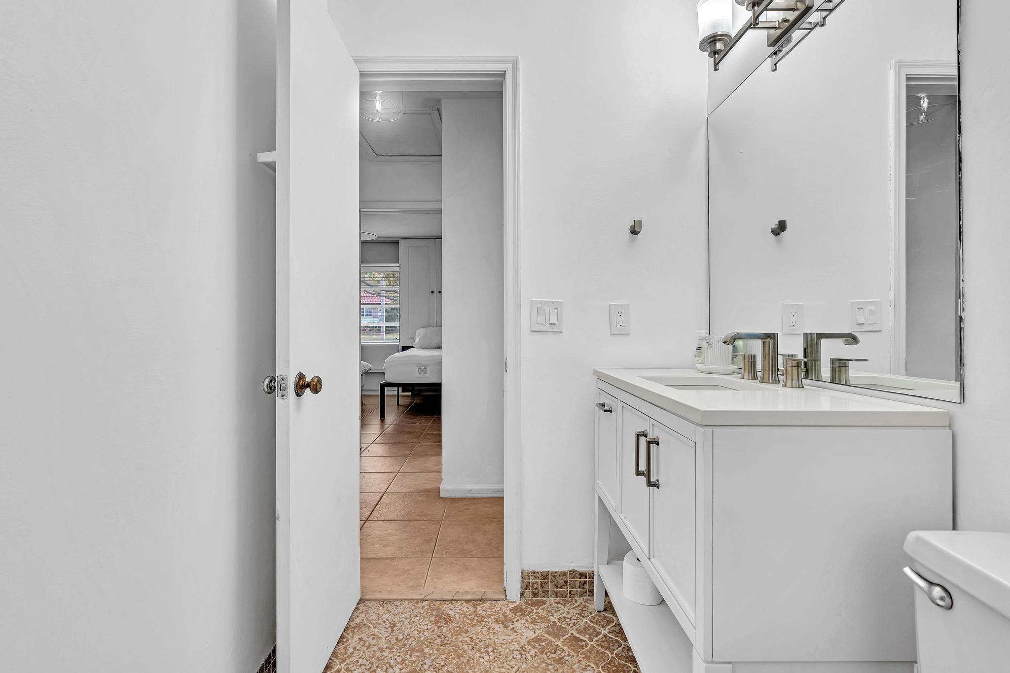 313 Northwest 42nd Street Boca Raton, FL 33431 - Photo 30 of 42 a bathroom with a sink and a mirror