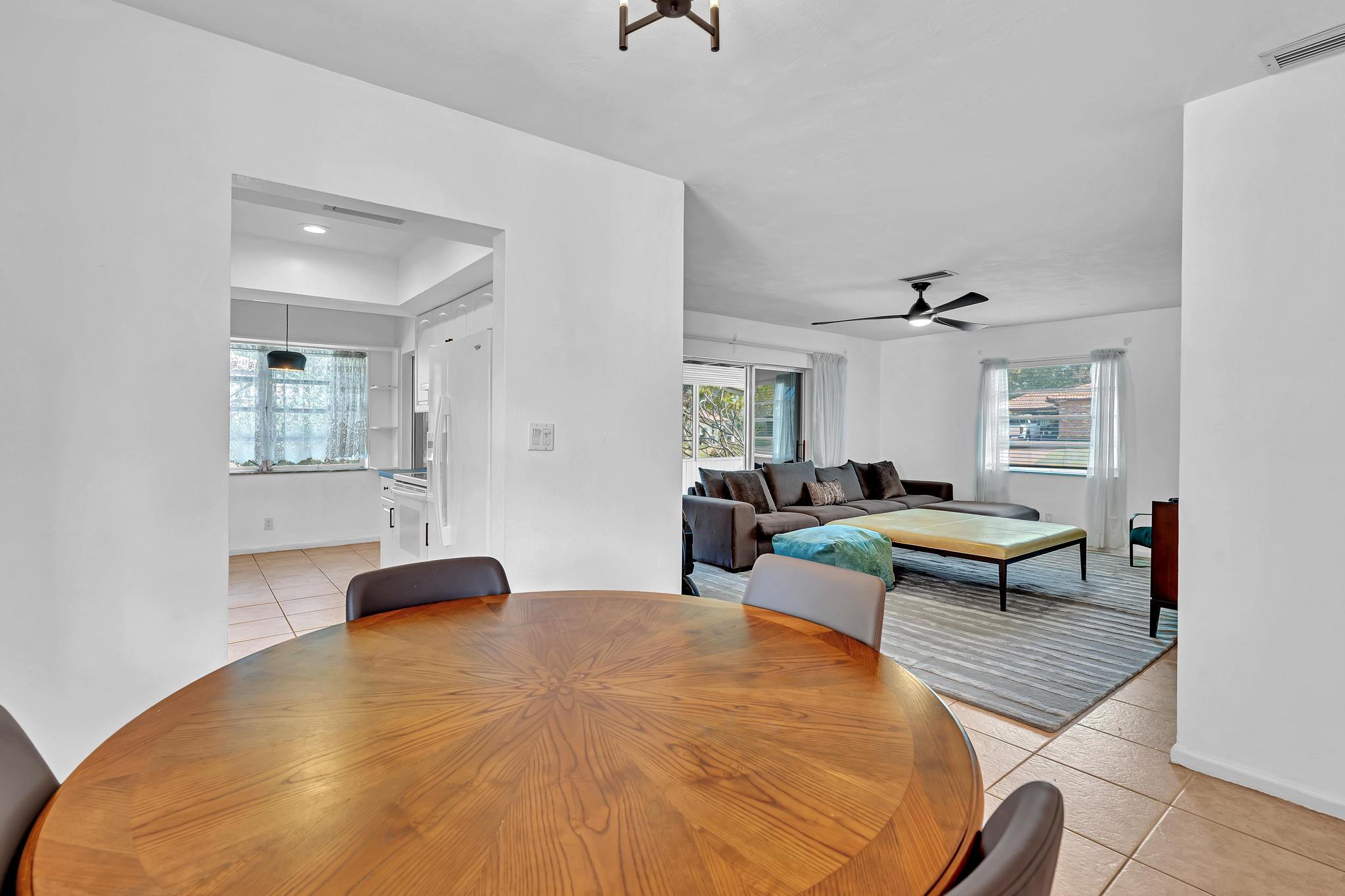 313 Northwest 42nd Street Boca Raton, FL 33431 - Photo 3 of 42 a living room with furniture a rug and painting on the wall