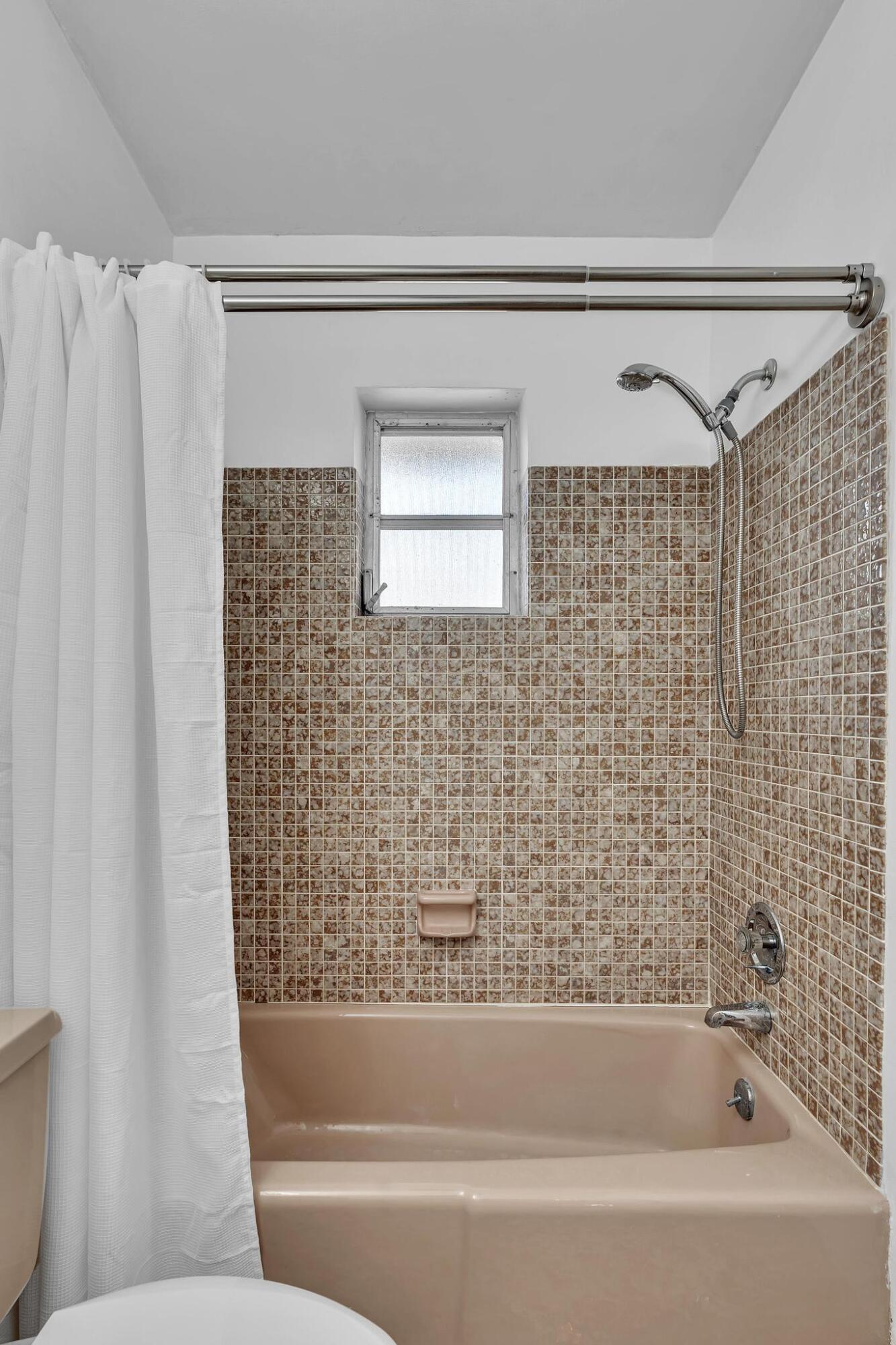 313 Northwest 42nd Street Boca Raton, FL 33431 - Photo 31 of 42 a bathroom with a bathtub and shower