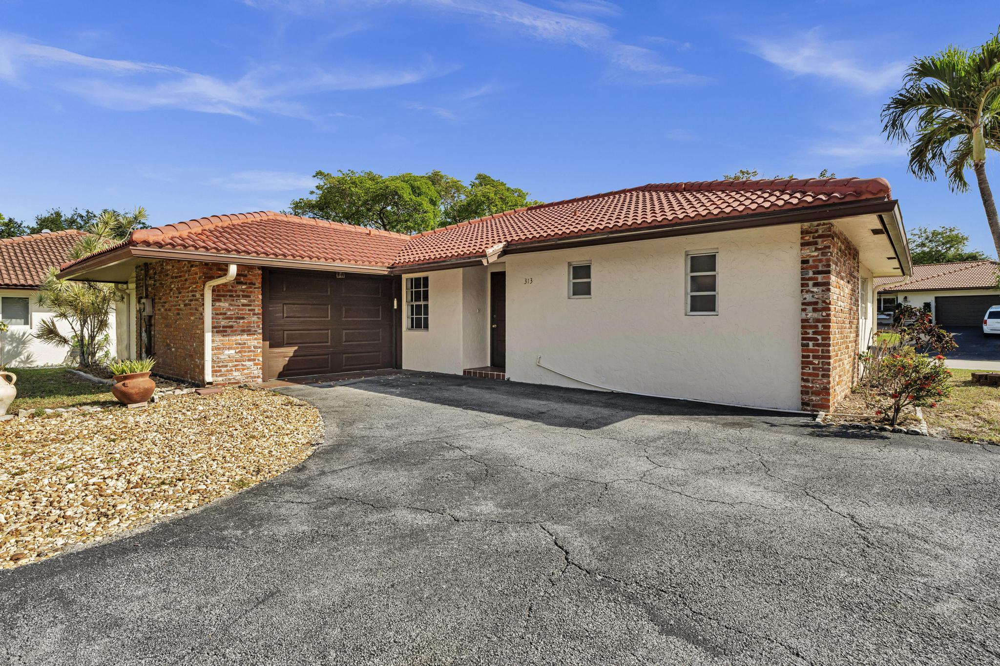 313 Northwest 42nd Street Boca Raton, FL 33431 - Photo 35 of 42 a view of a house with a patio