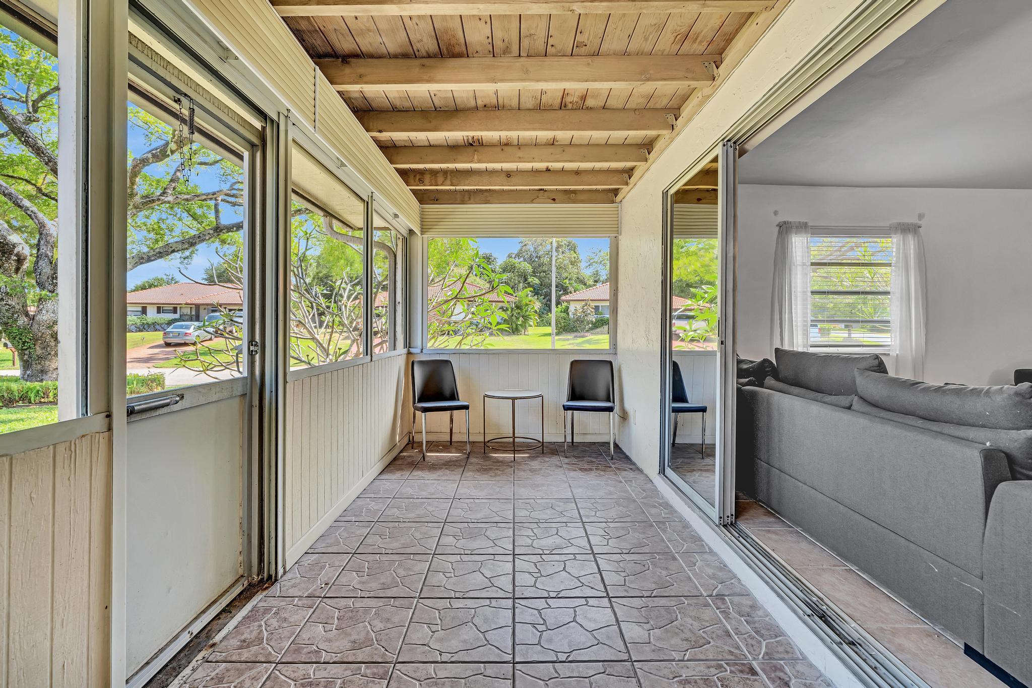 313 Northwest 42nd Street Boca Raton, FL 33431 - Photo 9 of 42 a view of a large room with wooden floor and furniture