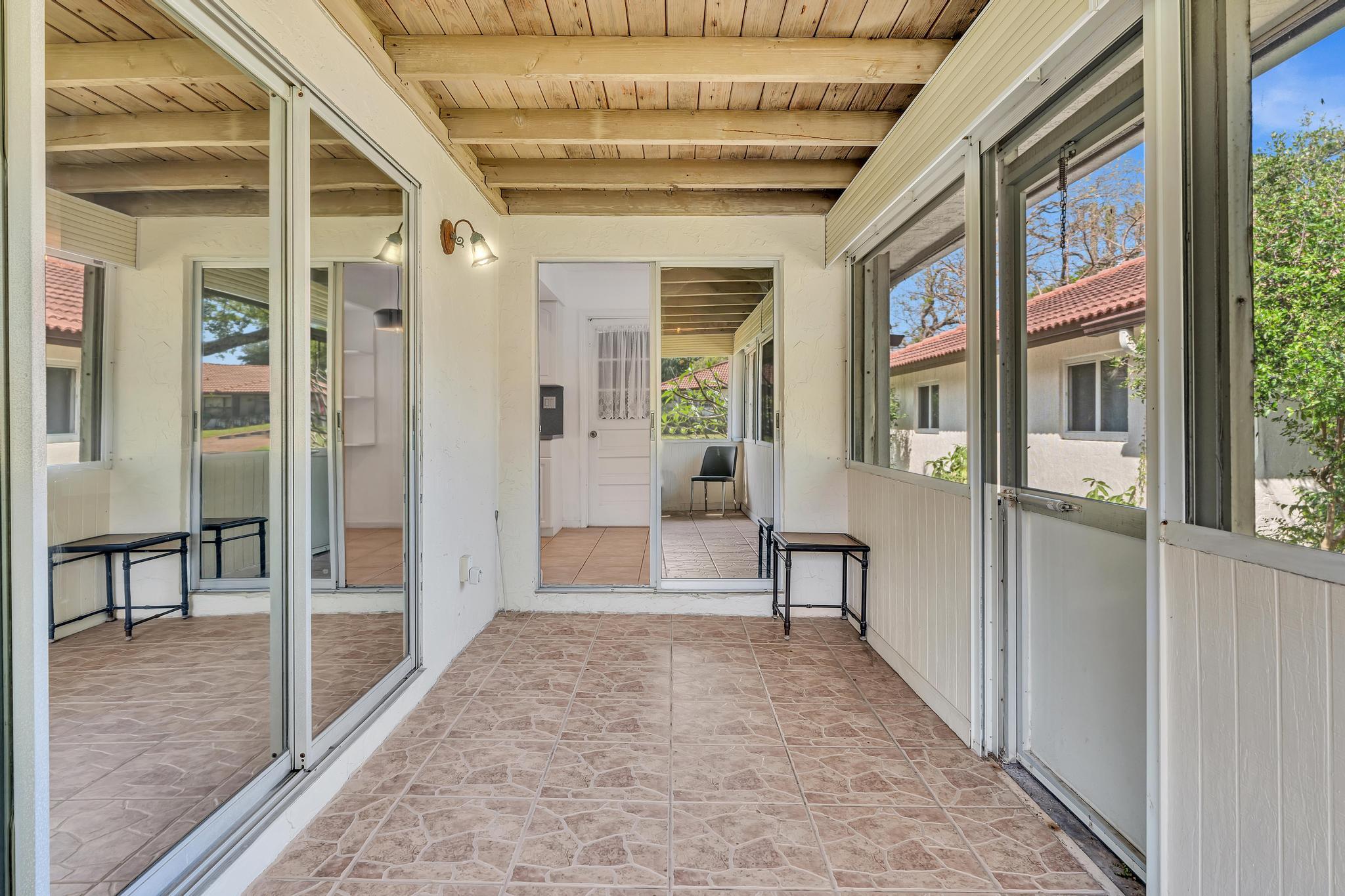 313 Northwest 42nd Street Boca Raton, FL 33431 - Photo 10 of 42 a view of a hallway with wooden floor and windows