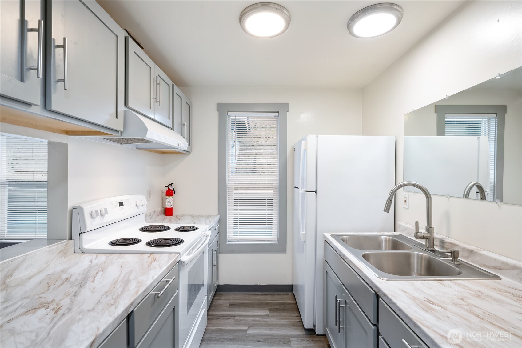 441-445 Smithers Avenue South Renton, WA 98057 - Photo 11 of 16 a kitchen with kitchen island stainless steel appliances granite countertop a sink a stove and refrigerator