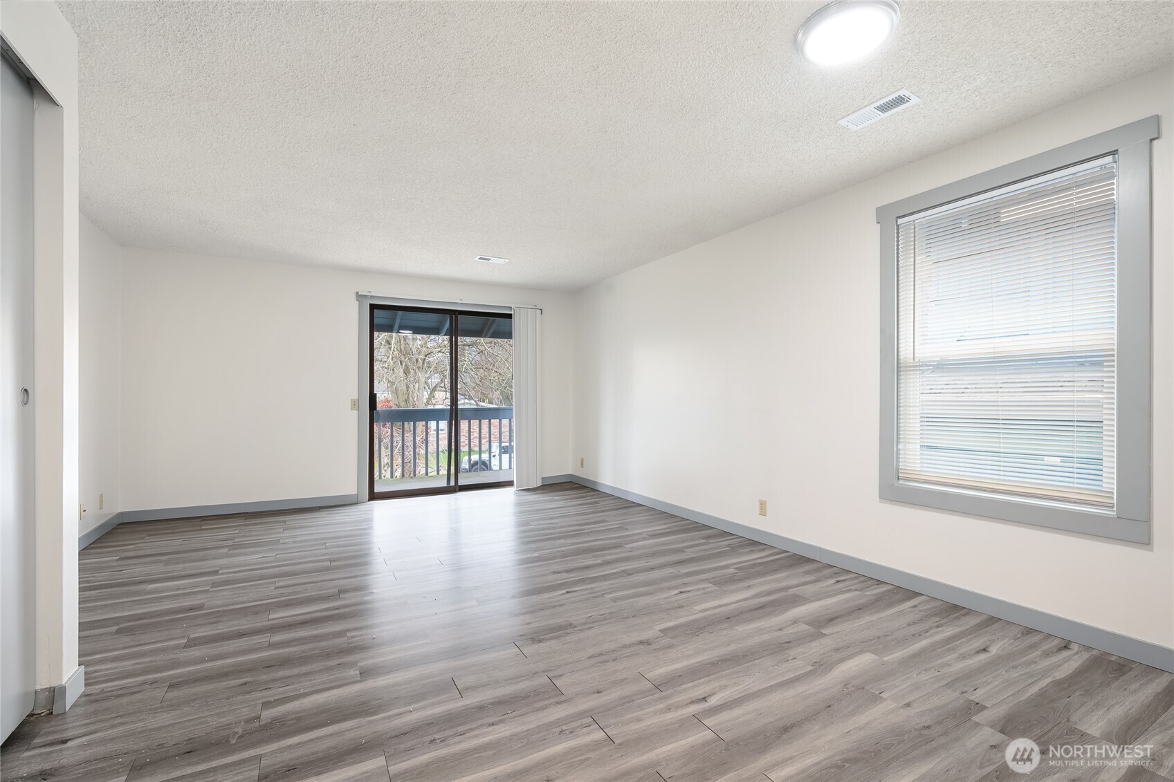 441-445 Smithers Avenue South Renton, WA 98057 - Photo 12 of 16 a view of an empty room with wooden floor and a window