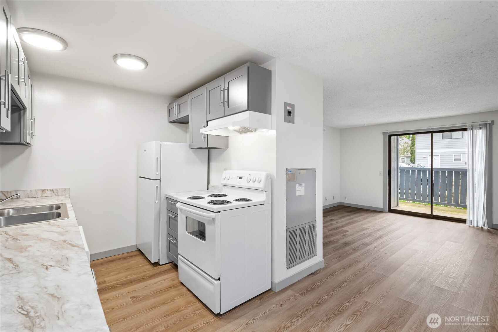 441-445 Smithers Avenue South Renton, WA 98057 - Photo 7 of 16 a kitchen with a stove and wooden floor