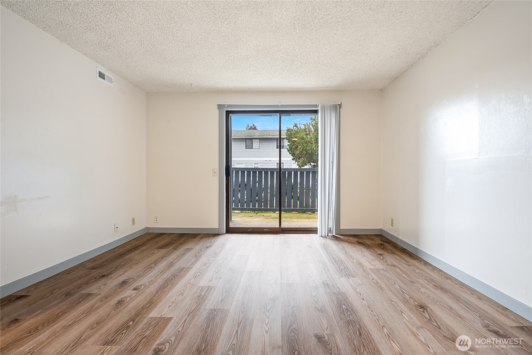 441-445 Smithers Avenue South Renton, WA 98057 - Photo 10 of 16 a view of an empty room with wooden floor and a window
