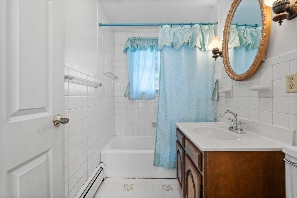 41 Durham Street Lawrence, MA 01843 - Photo 14 of 28 a bathroom with a sink a mirror and a bathtub
