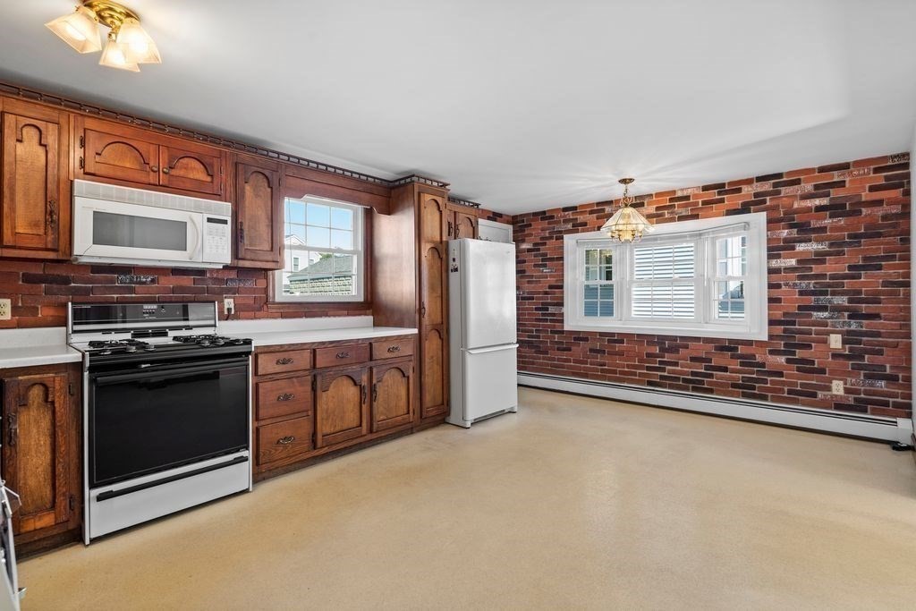 41 Durham Street Lawrence, MA 01843 - Photo 9 of 28 a kitchen with stainless steel appliances granite countertop a stove a sink and a microwave