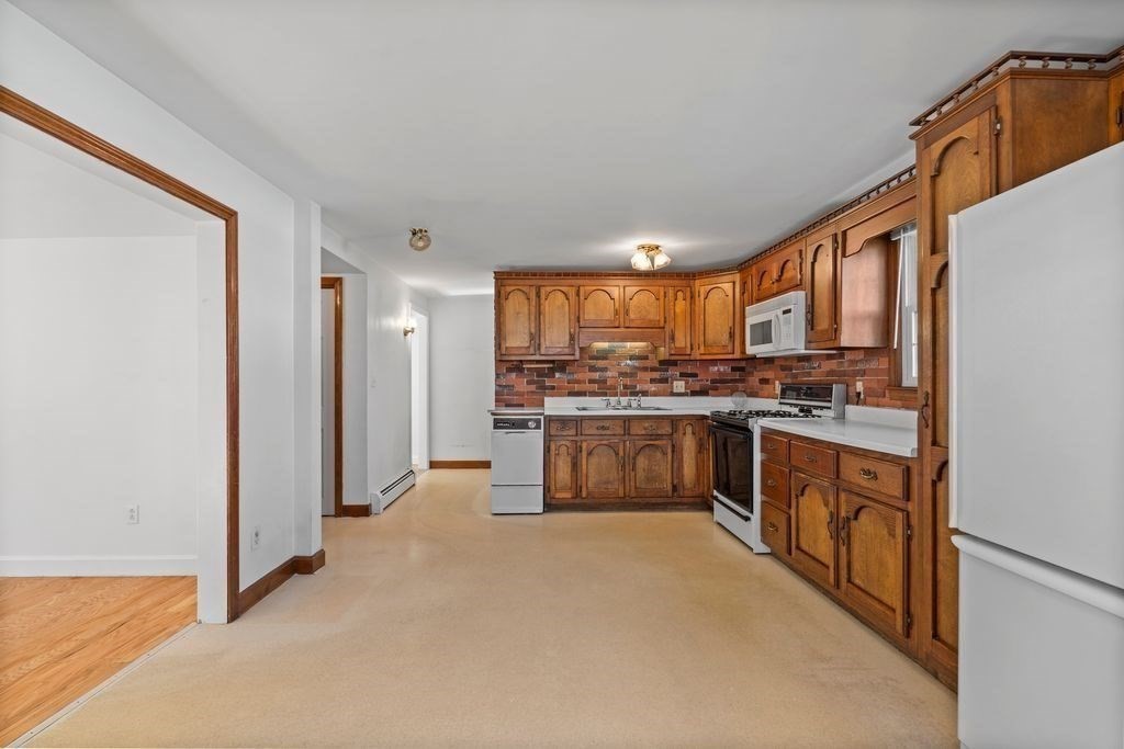 41 Durham Street Lawrence, MA 01843 - Photo 10 of 28 a kitchen with stainless steel appliances a refrigerator and a stove top oven