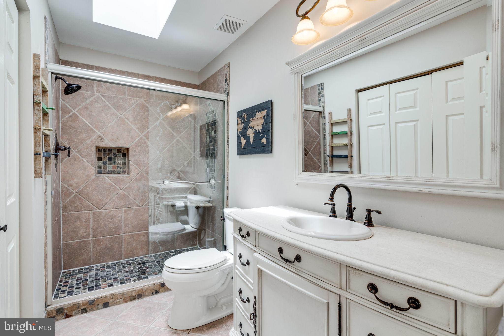 8959 Sycamore Ridge Road Fairfax Station, VA 22039 - Photo 38 of 63 Remodeled hall bathroom with SKYLIGHT!