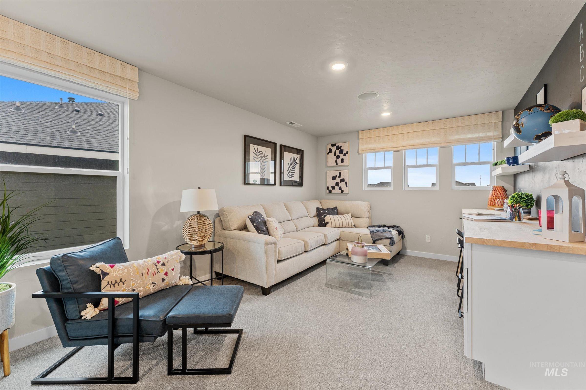 4149 South Colditz Way Meridian, ID 83642 - Photo 15 of 42 Living room featuring light colored carpet and baseboards