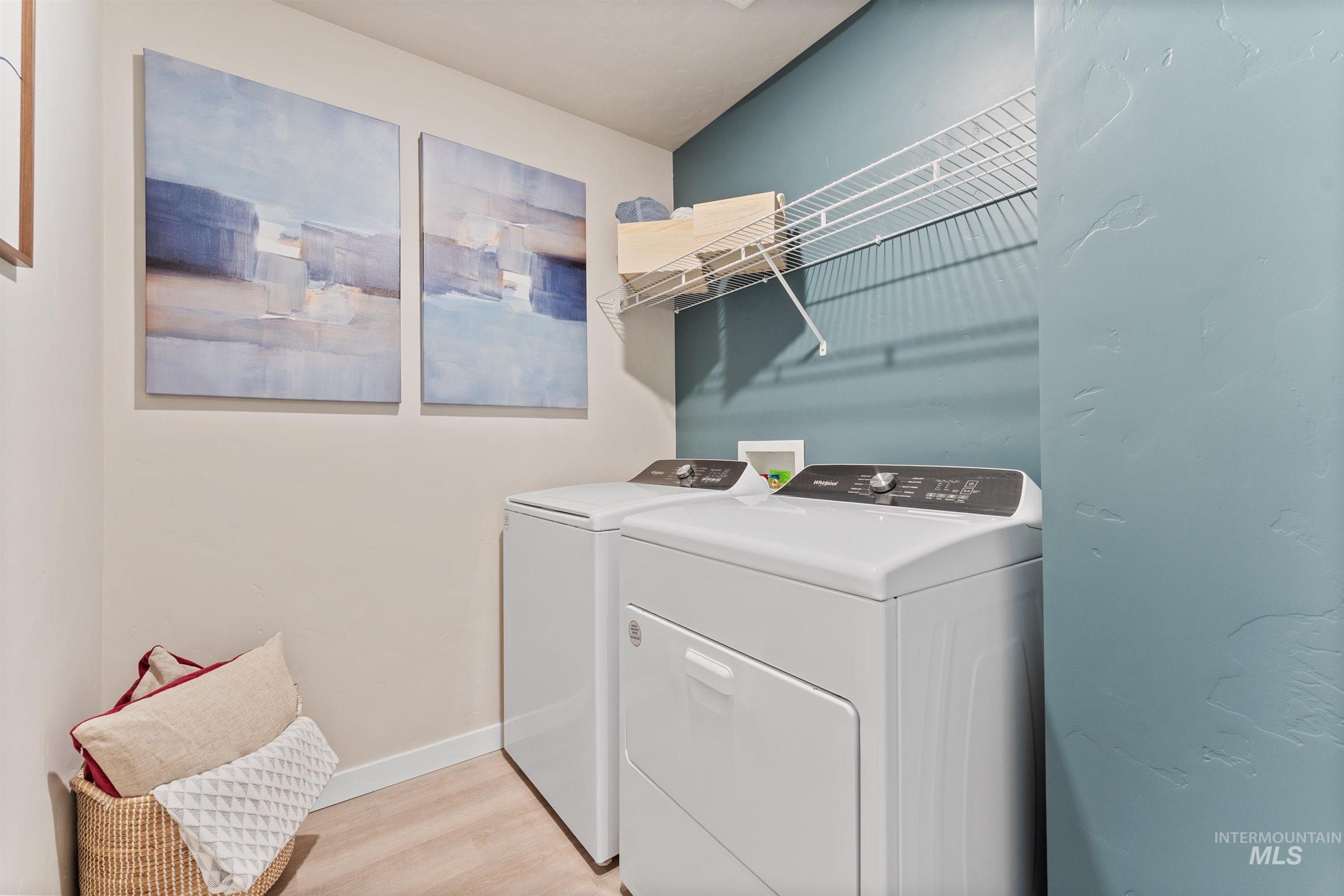 4149 South Colditz Way Meridian, ID 83642 - Photo 27 of 42 Laundry area featuring light wood finished floors and washer and dryer
