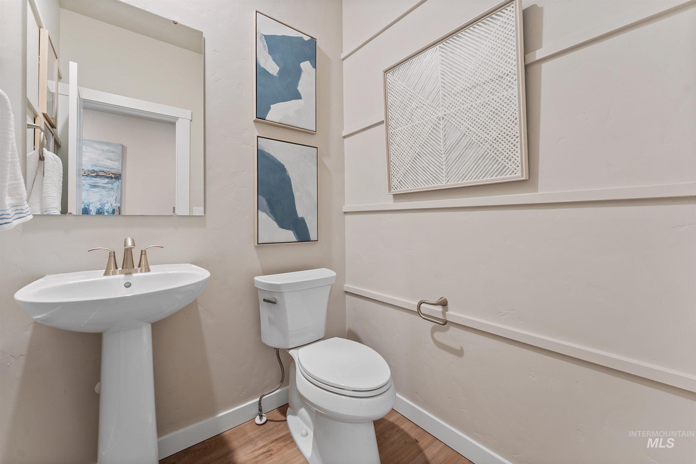 4149 South Colditz Way Meridian, ID 83642 - Photo 5 of 42 Half bathroom with toilet and wood finished floors