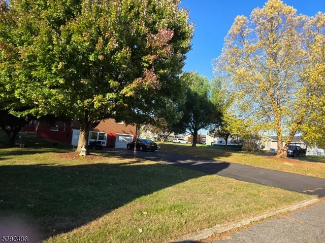 a view of yard with swimming pool and trees
